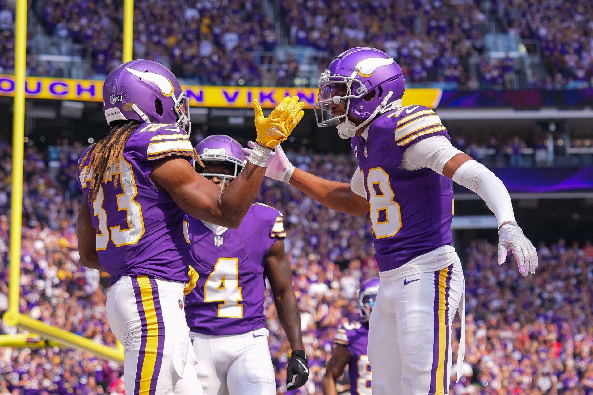 Sep 22, 2024; Minneapolis, Minnesota, USA; Minnesota Vikings running back Aaron Jones (33) celebrates his touchdown with wide receiver Justin Jefferson (18) against the Houston Texans in the first quarter at U.S. Bank Stadium. Mandatory Credit: Brad Rempel-Imagn Images