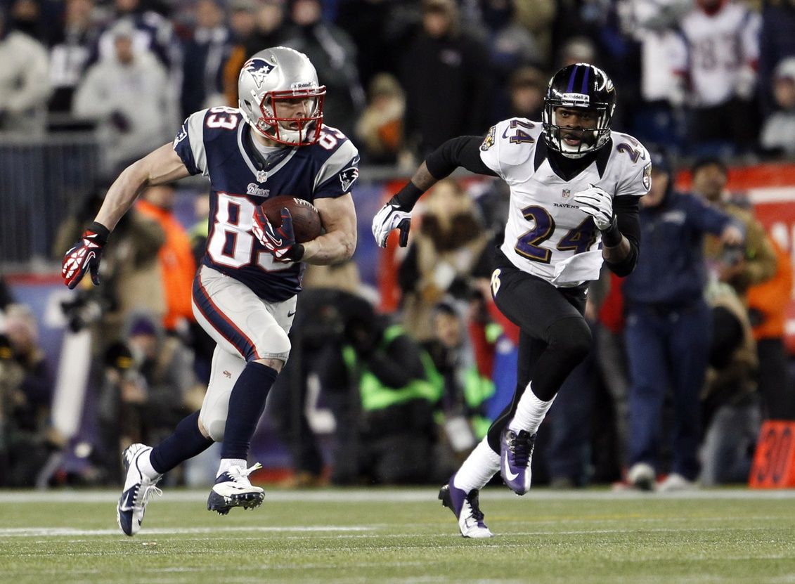 New England Patriots wide receiver Wes Welker (83) runs past Baltimore Ravens cornerback Corey Graham (24) during the fourth quarter of the AFC championship game at Gillette Stadium. Mandatory Credit: David Butler II-USA TODAY Sports