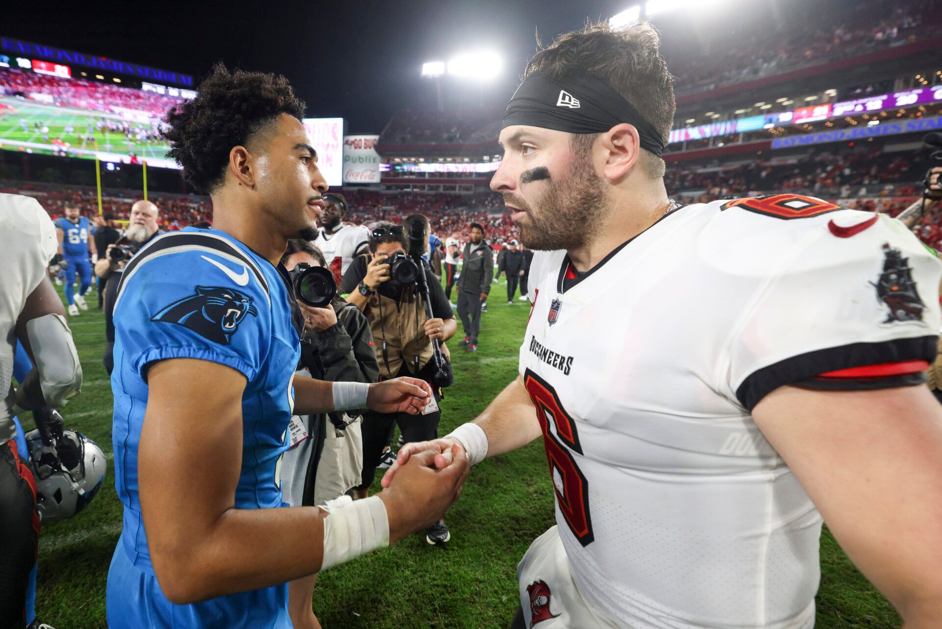 Dec 3, 2023; Tampa, Florida, USA; Tampa Bay Buccaneers quarterback Baker Mayfield (6) greats Carolina Panthers quarterback Bryce Young (9) after a game at Raymond James Stadium. Mandatory Credit: Nathan Ray Seebeck-USA TODAY Sports