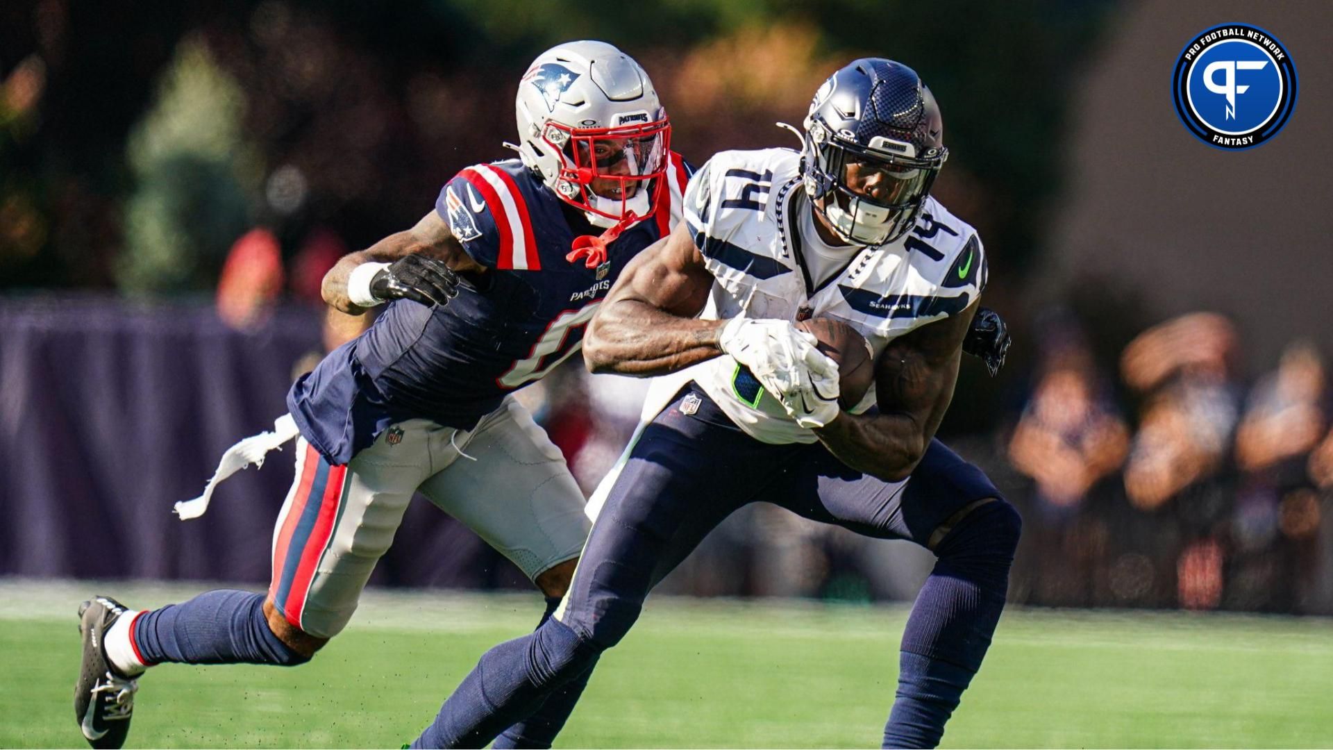 Sep 15, 2024; Foxborough, Massachusetts, USA; Seattle Seahawks wide receiver DK Metcalf (14) runs the ball against New England Patriots cornerback Christian Gonzalez (0) in the second half at Gillette Stadium. Mandatory Credit: David Butler II-Imagn Images