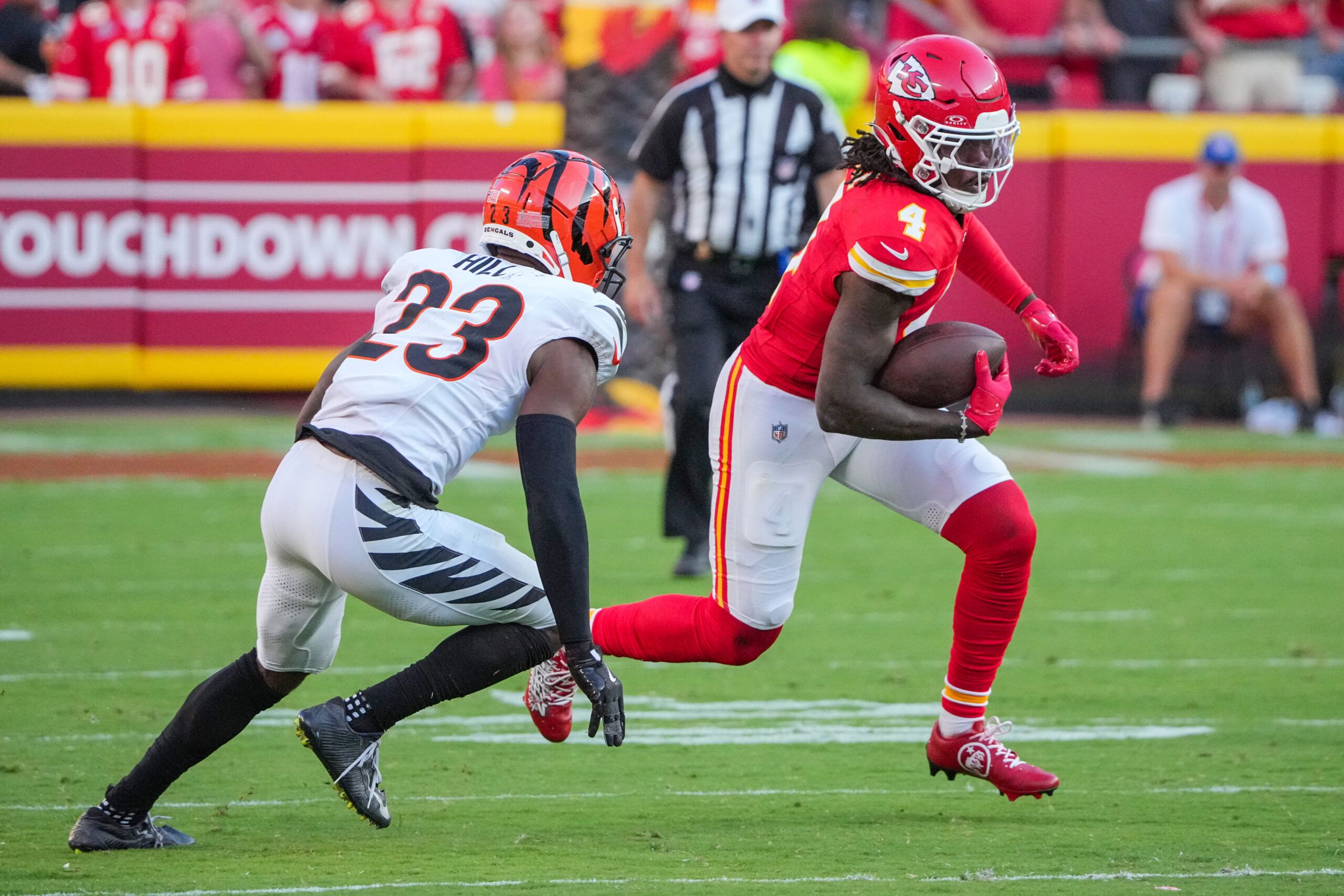 Sep 15, 2024; Kansas City, Missouri, USA; Kansas City Chiefs wide receiver Rashee Rice (4) runs the ball as Cincinnati Bengals cornerback Dax Hill (23) attempts the tackle during the second half at GEHA Field at Arrowhead Stadium. Mandatory Credit: Denny Medley-Imagn Images