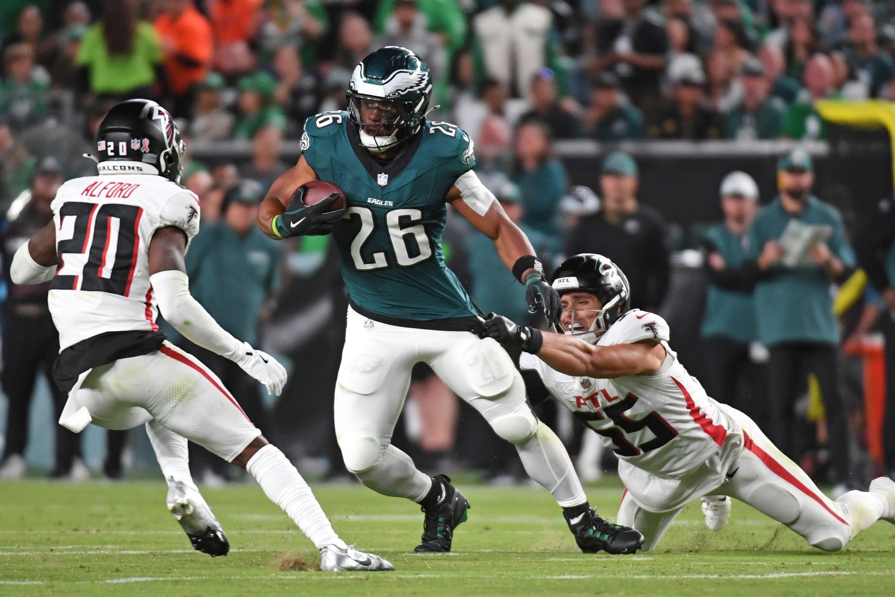 Philadelphia Eagles running back Saquon Barkley (26) tries to get way from Atlanta Falcons cornerback Dee Alford (20) and linebacker Kaden Elliss (55) at Lincoln Financial Field.