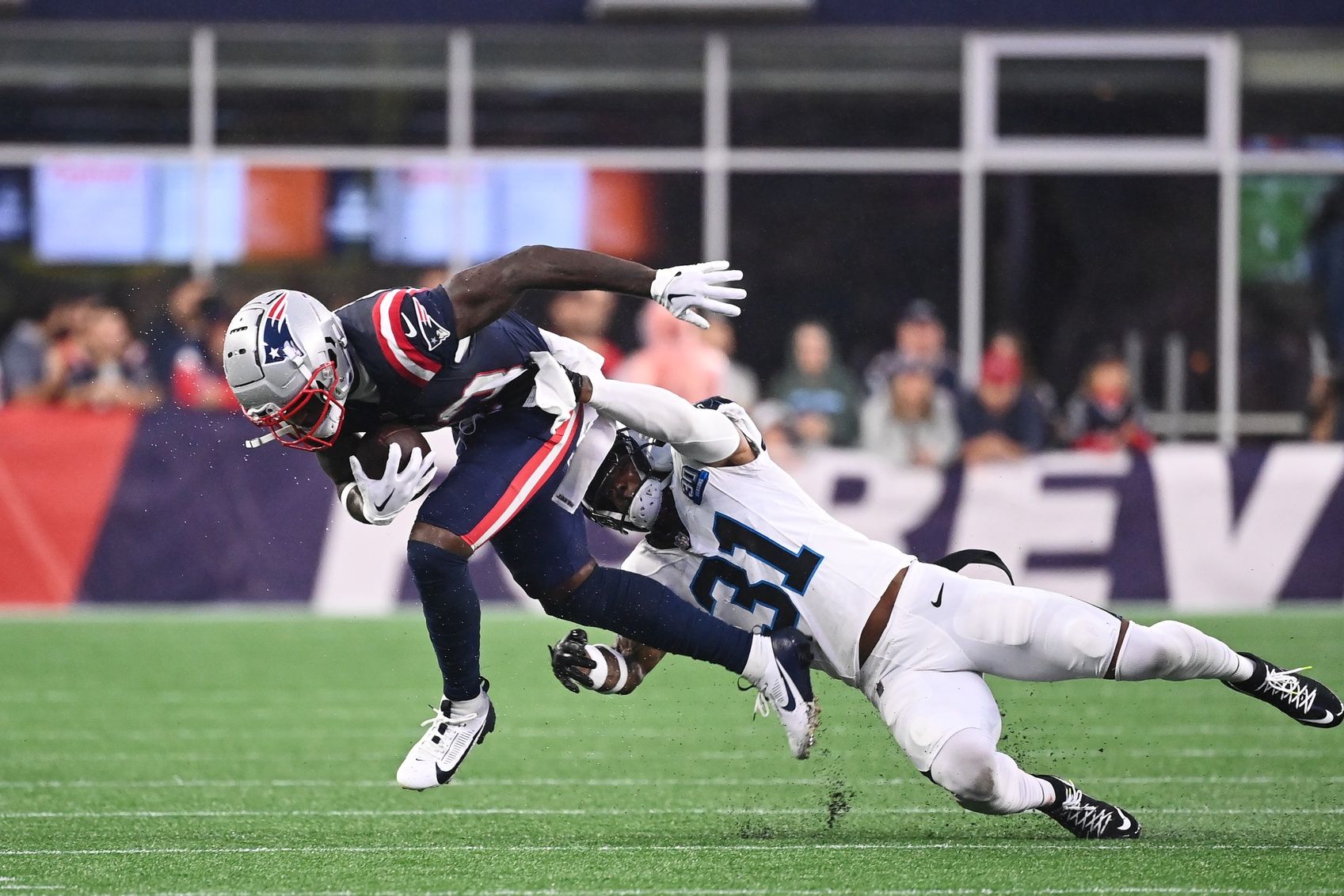 Carolina Panthers cornerback Lamar Jackson (31) tackles New England Patriots wide receiver Jalen Reagor (83) during the first half at Gillette Stadium.