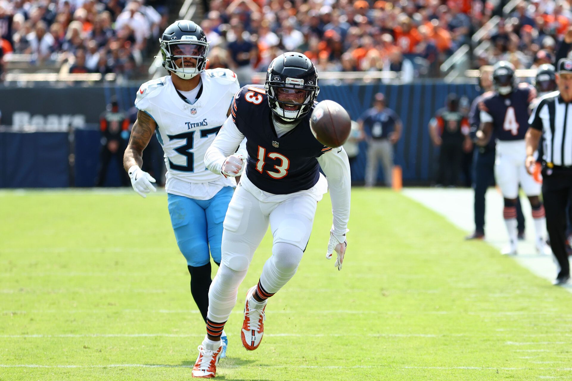 Sep 8, 2024; Chicago, Illinois, USA; Chicago Bears wide receiver Keenan Allen (13) attempts to make a catch against Tennessee Titans safety Amani Hooker (37) during the second half at Soldier Field. Mandatory Credit: Mike Dinovo-Imagn Images