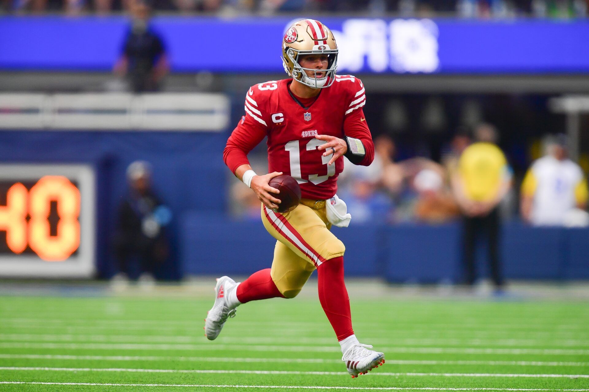 Sep 22, 2024; Inglewood, California, USA; San Francisco 49ers quarterback Brock Purdy (13) runs the ball against the Los Angeles Rams during the second half at SoFi Stadium. Mandatory Credit: Gary A. Vasquez-Imagn Images