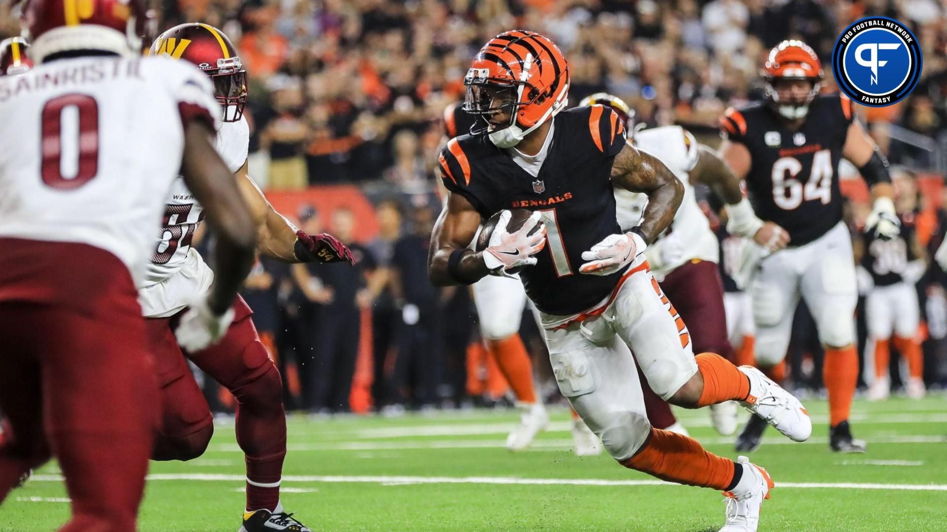 Cincinnati Bengals wide receiver Ja'Marr Chase (1) runs with the ball against the Washington Commanders in the second half at Paycor Stadium.