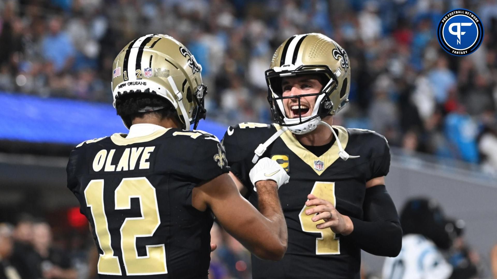 Sep 18, 2023; Charlotte, North Carolina, USA; New Orleans Saints quarterback Derek Carr (4) reacts with wide receiver Chris Olave (12) in the fourth quarter at Bank of America Stadium. Mandatory Credit: Bob Donnan-Imagn Images