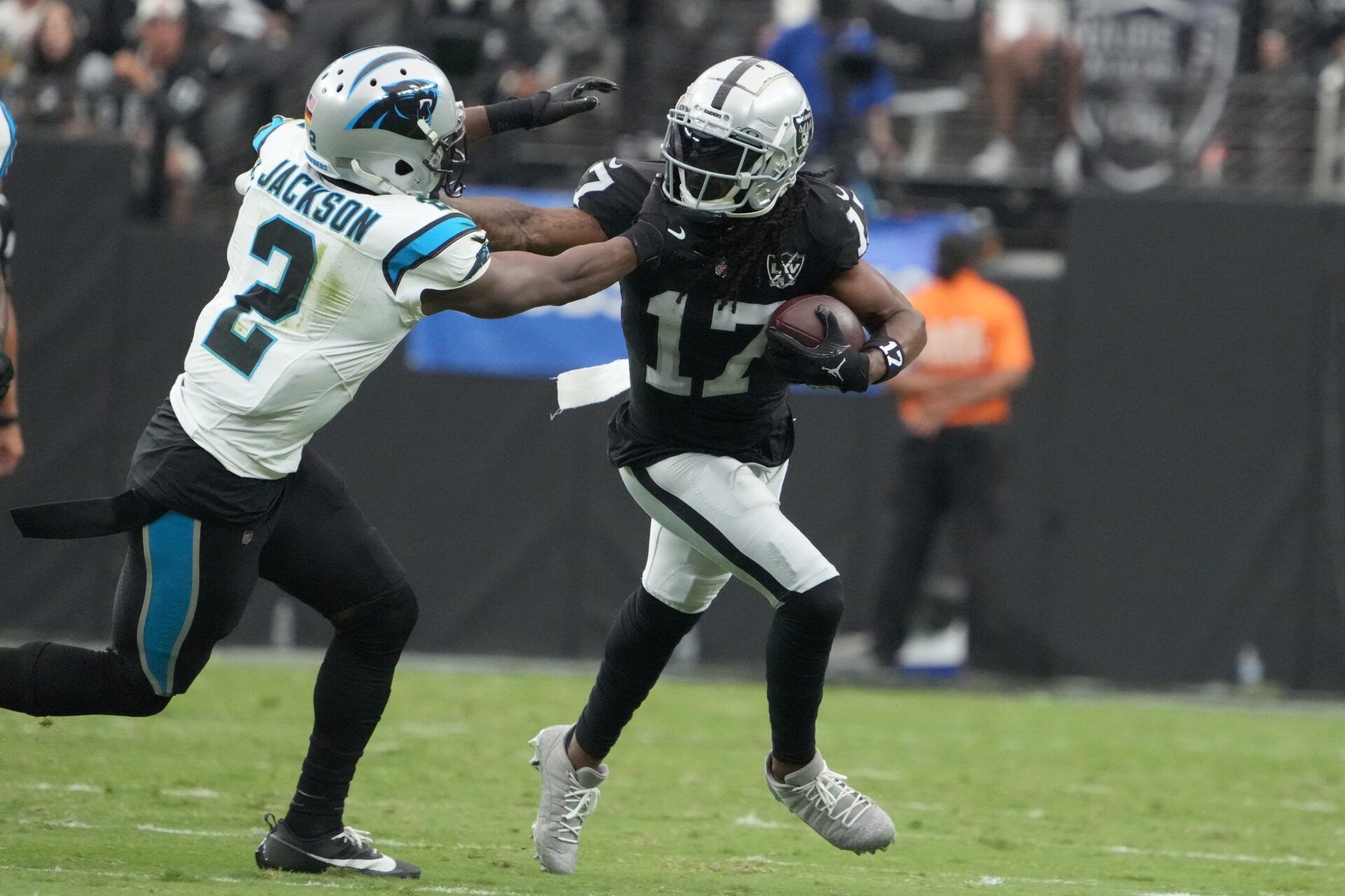 Las Vegas Raiders wide receiver Davante Adams (17) carries the ball against Carolina Panthers cornerback Michael Jackson (2) in the first half at Allegiant Stadium.