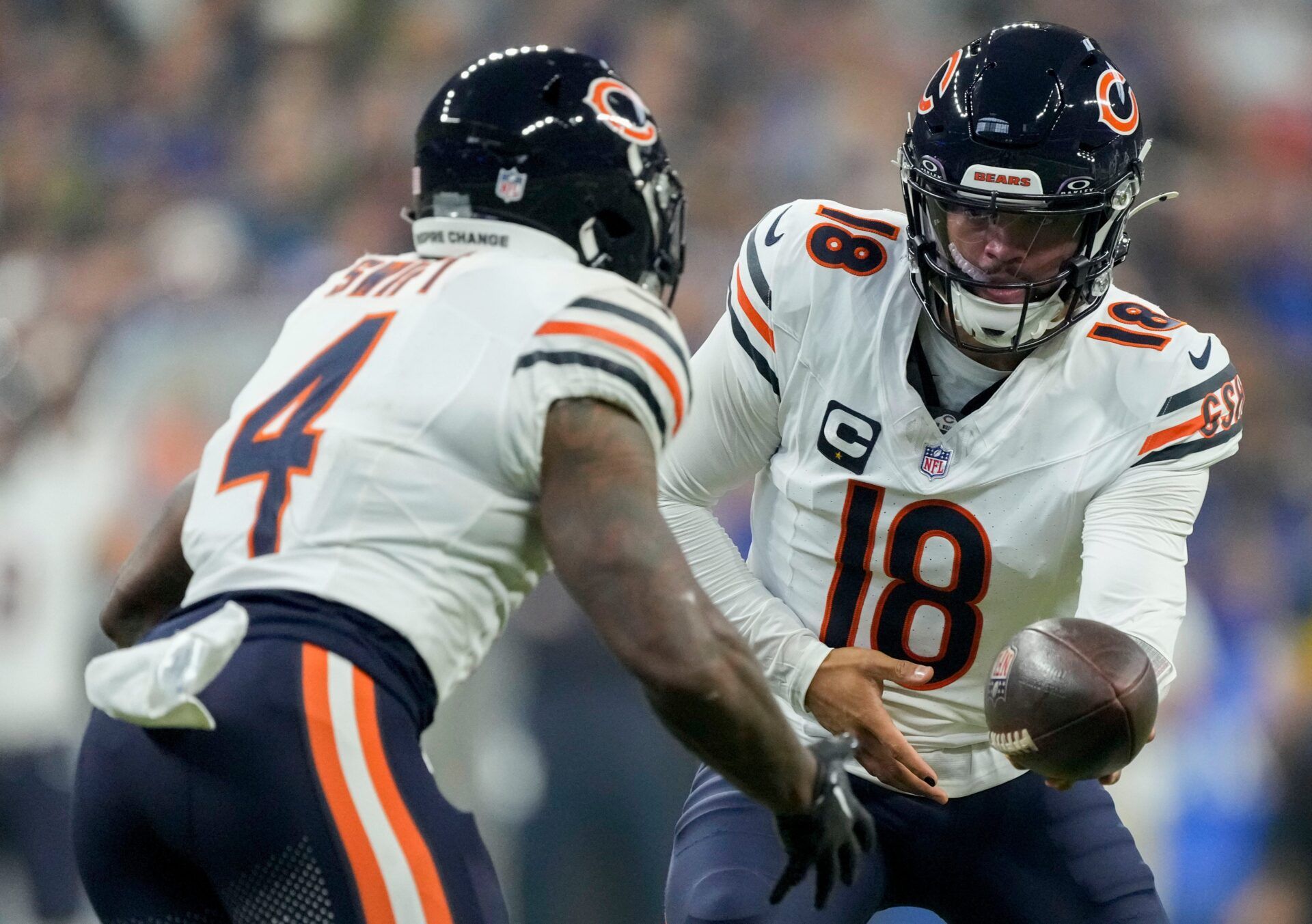 Chicago Bears quarterback Caleb Williams (18) hands the ball to Chicago Bears running back D'Andre Swift (4) on Sunday, Sept. 22, 2024, during a game against the Indianapolis Colts at Lucas Oil Stadium in Indianapolis.