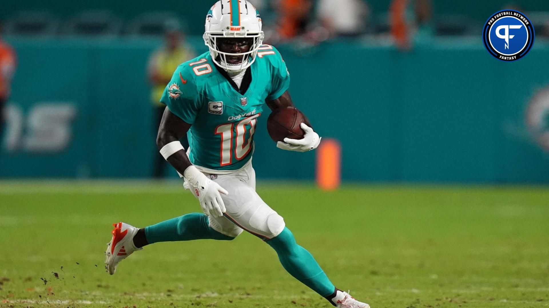 Miami Dolphins wide receiver Tyreek Hill (10) runs with the ball during the first half against the Tennessee Titans at Hard Rock Stadium.