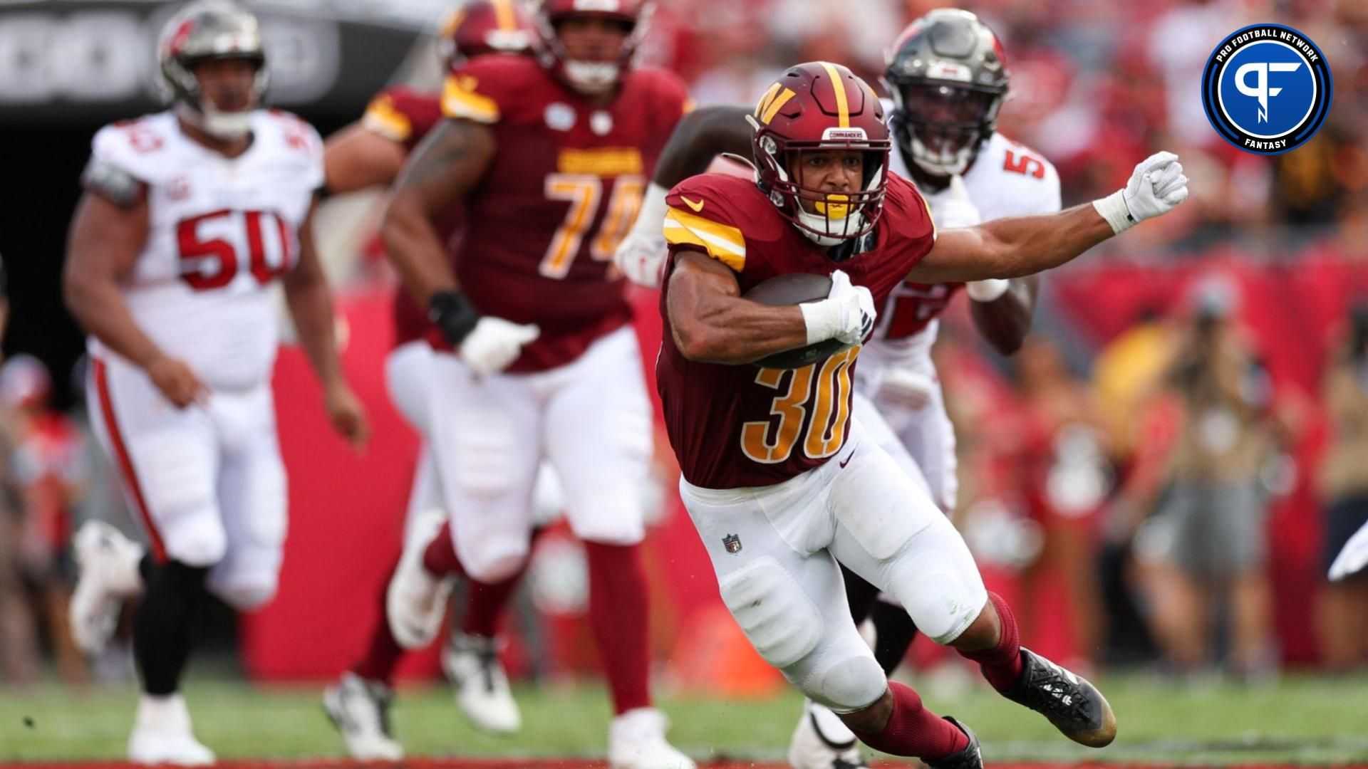 Washington Commanders running back Austin Ekeler (30) runs with the ball against the Tampa Bay Buccaneers in the second quarter at Raymond James Stadium.