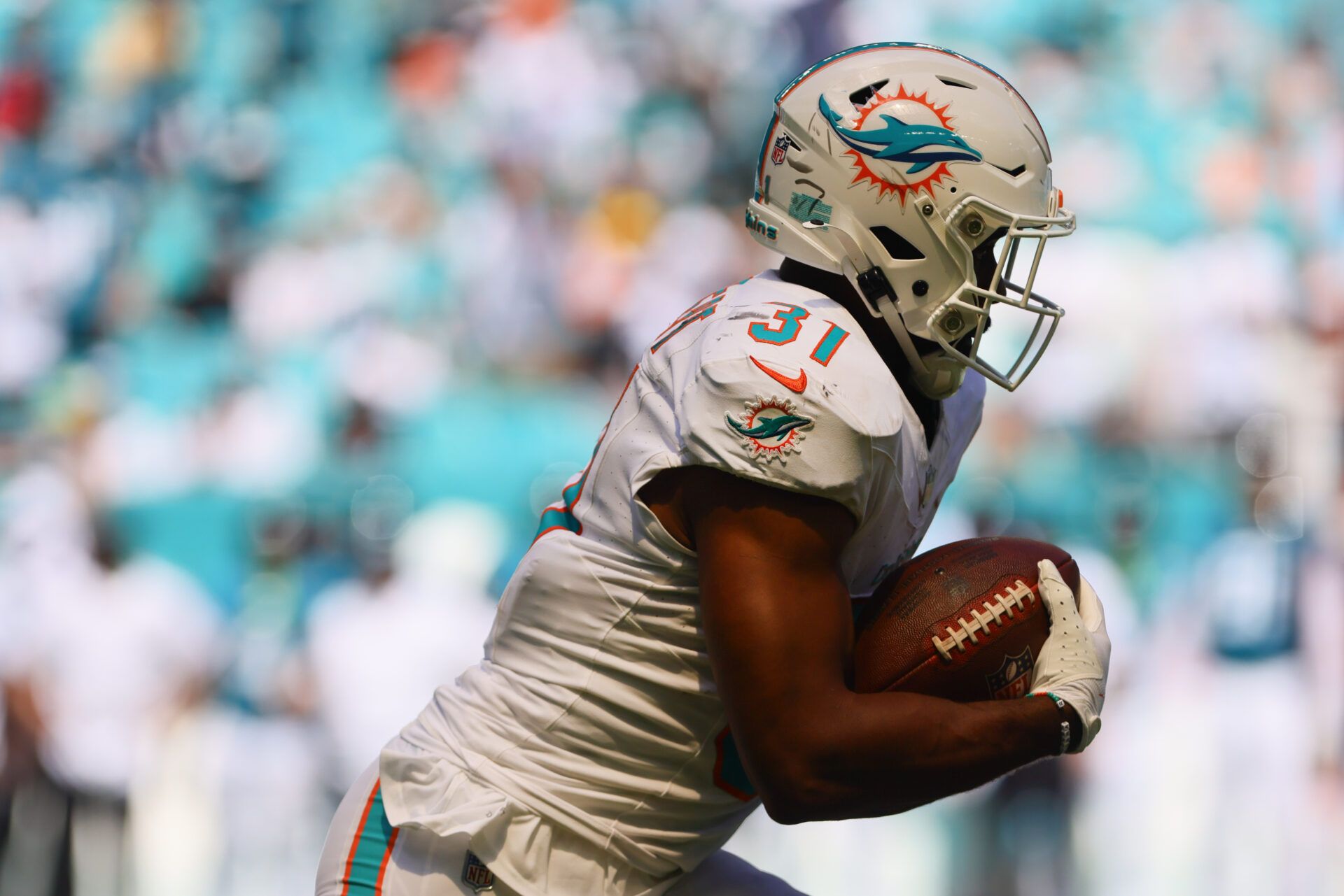 Sep 8, 2024; Miami Gardens, Florida, USA; Miami Dolphins running back Raheem Mostert (31) runs with the football against the Jacksonville Jaguars during the third quarter at Hard Rock Stadium. Mandatory Credit: Sam Navarro-Imagn Images