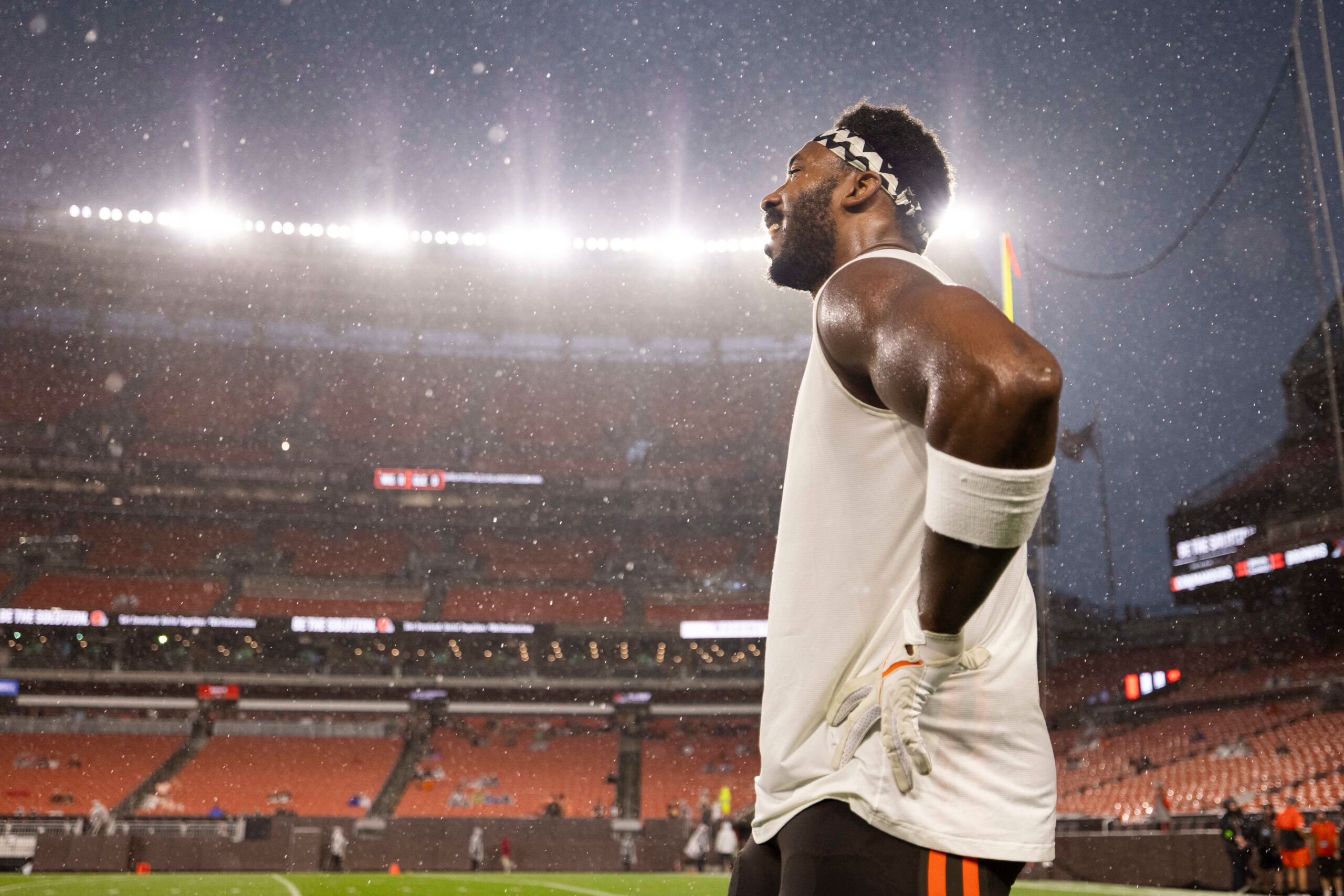 Cleveland Browns defensive end Myles Garrett (95) stands in the rain before the game against the Washington Commanders which was delayed due to severe weather at Cleveland Browns Stadium.