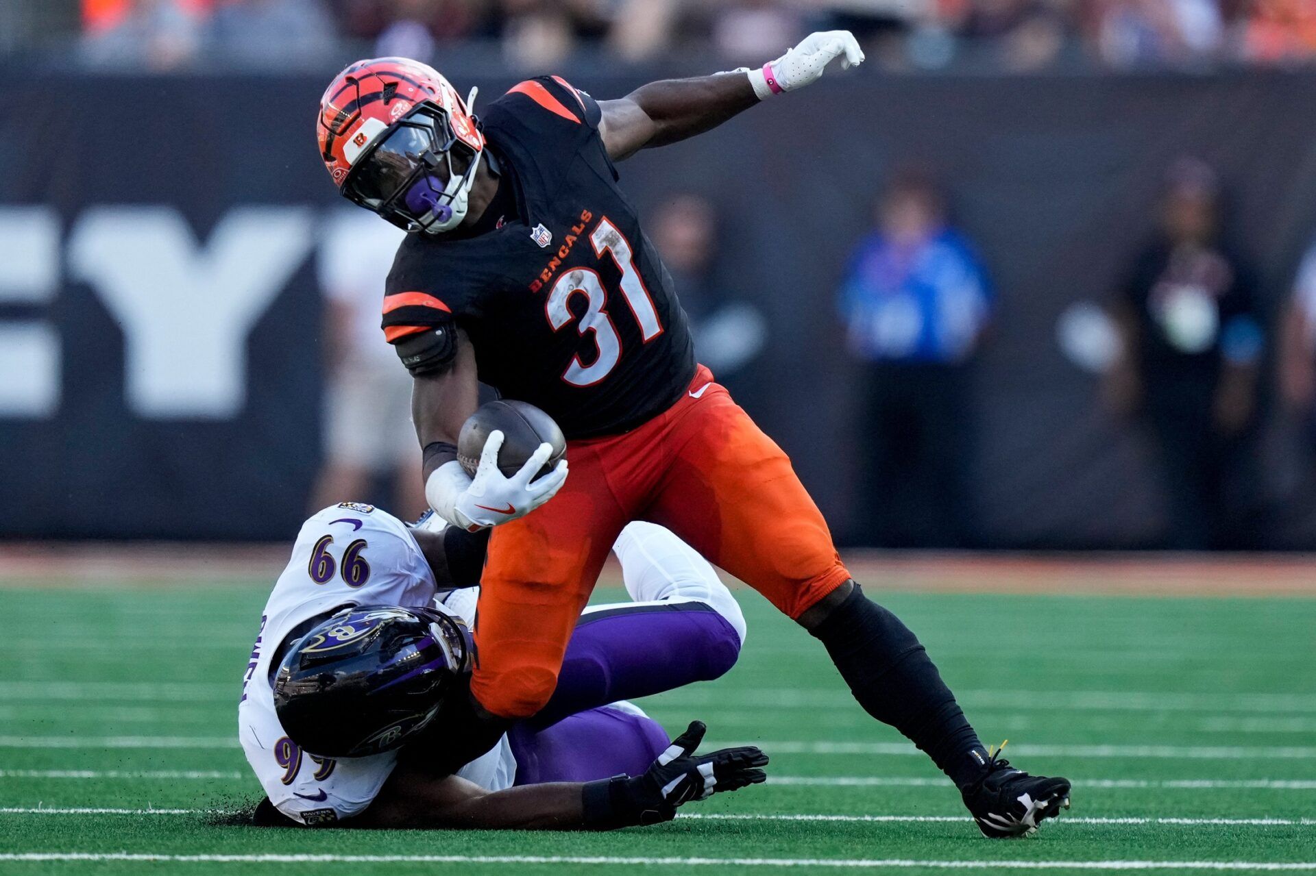 Baltimore Ravens outside linebacker Odafe Oweh (99) comes down on the lower leg of Cincinnati Bengals halfback Zack Moss (31) as he runs the ball in the fourth quarter of the NFL Week 5 game between the Cincinnati Bengals and Baltimore Ravens at Paycor Stadium in downtown Cincinnati on Sunday, Oct. 6, 2024. The Bengals fell to 1-4 on the season with a 41-38 loss to the Ravens.