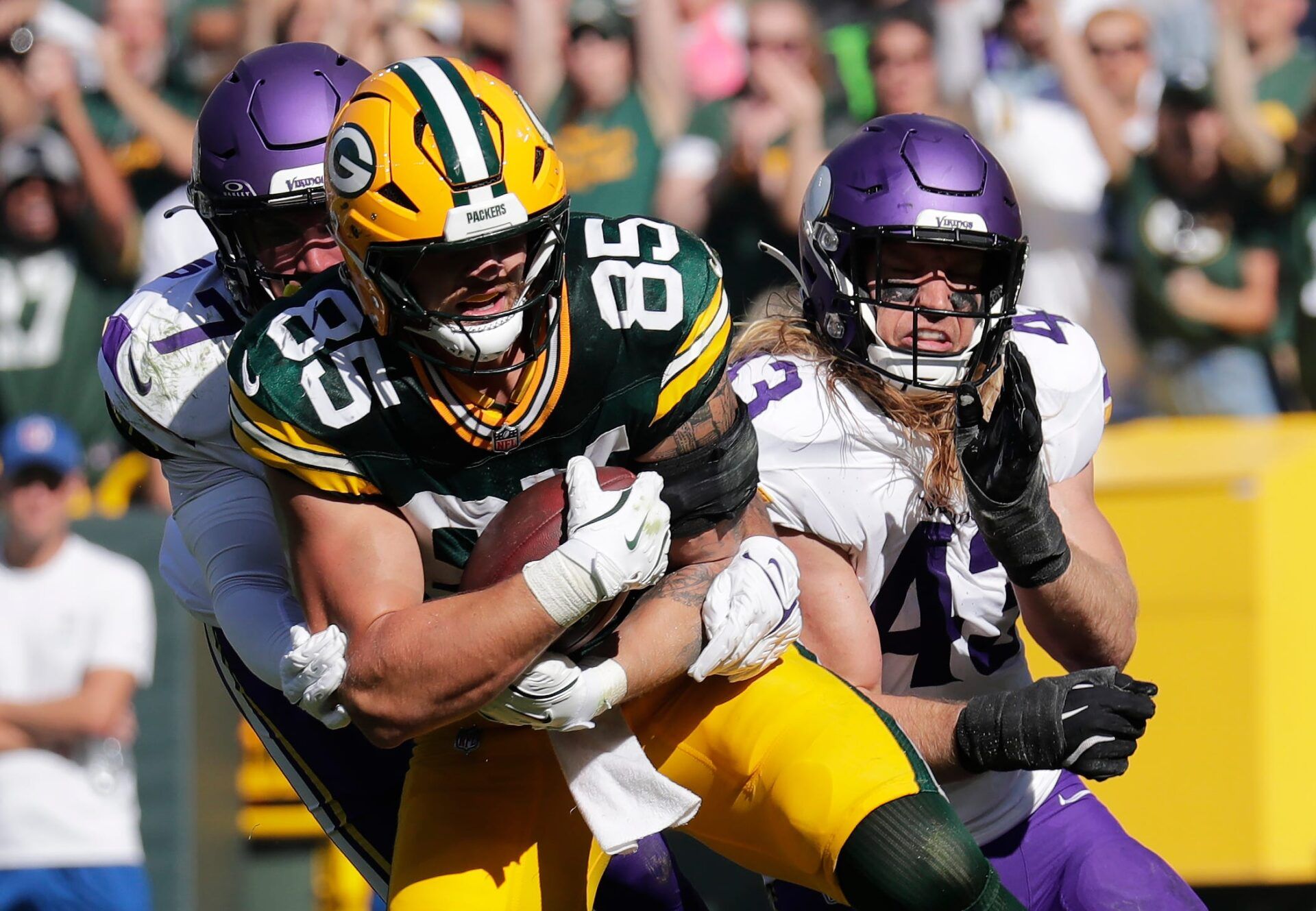 Green Bay Packers tight end Tucker Kraft (85) scores a two point conversion in the fourth quarter against Minnesota Vikings cornerback Byron Murphy Jr. (7) and Andrew Van Ginkel (43) during their football game Sunday, September 29, 2024, at Lambeau Field in Green Bay, Wisconsin.