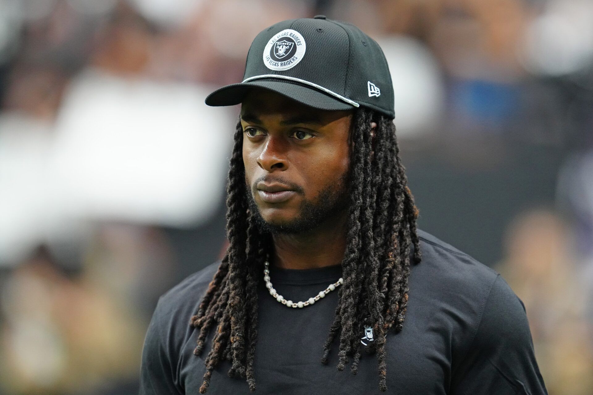 Las Vegas Raiders wide receiver Davante Adams (17) walks the sideline before the start of a game between the Raiders and the Cleveland Browns at Allegiant Stadium.