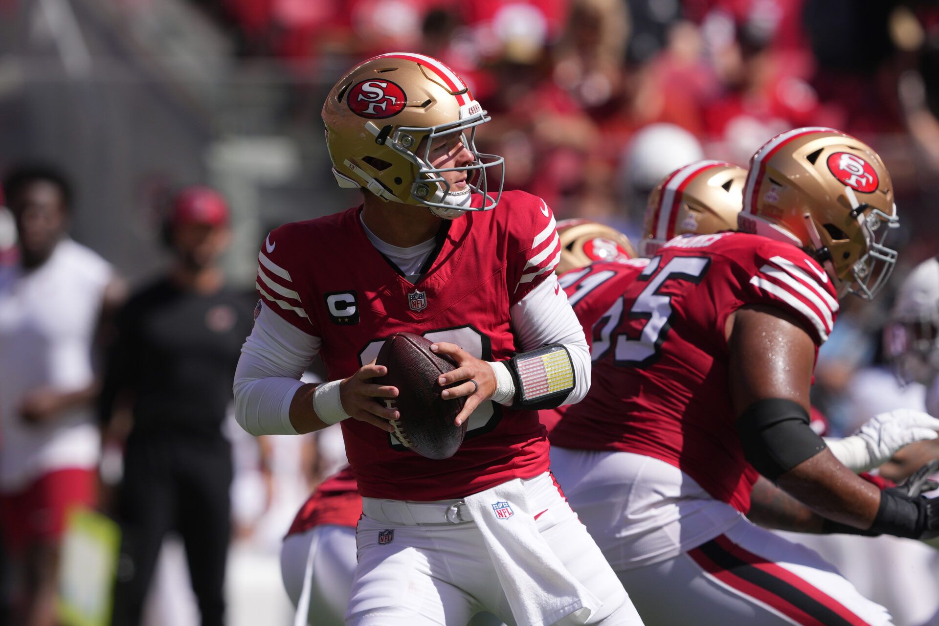 Oct 6, 2024; Santa Clara, California, USA; San Francisco 49ers quarterback Brock Purdy (13) drops back to pass against the Arizona Cardinals during the first quarter at Levi's Stadium. Mandatory Credit: Darren Yamashita-Imagn Images