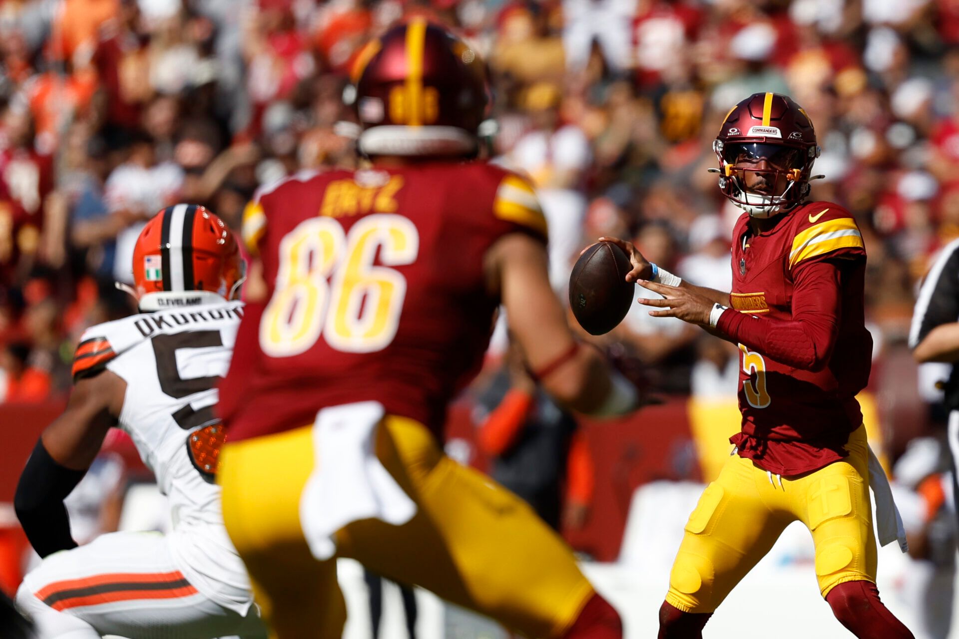 Oct 6, 2024; Landover, Maryland, USA; Washington Commanders quarterback Jayden Daniels (5) prepares to pass the ball to Commanders tight end Zach Ertz (86) against the Cleveland Browns during the second quarter at NorthWest Stadium. Mandatory Credit: Geoff Burke-Imagn Images