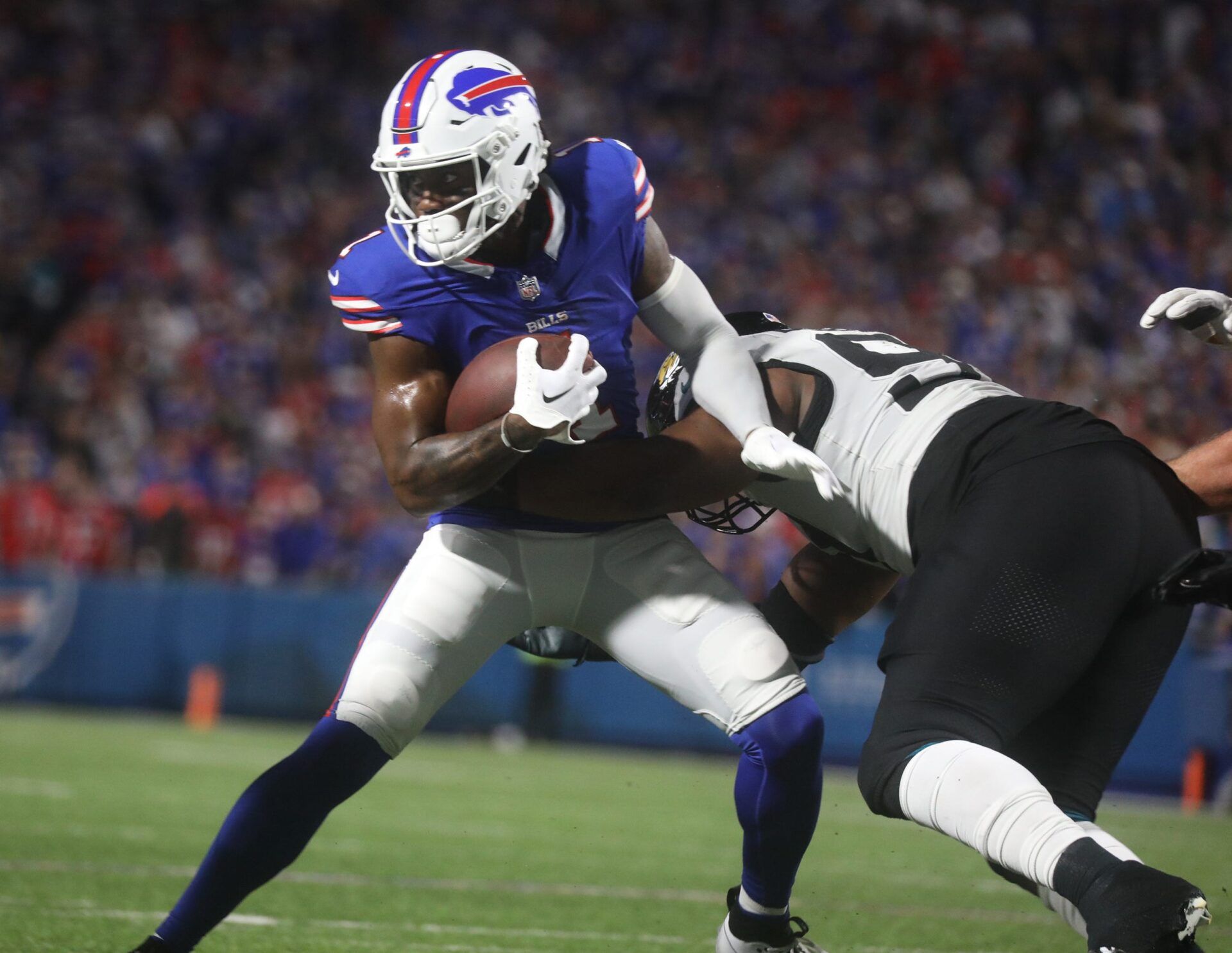 Bills Curtis Samuel runs with the ball and tries to shake off a Jaguars defensive player during first half action at Highmark Stadium in Orchard Park on Sept. 23, 2024.