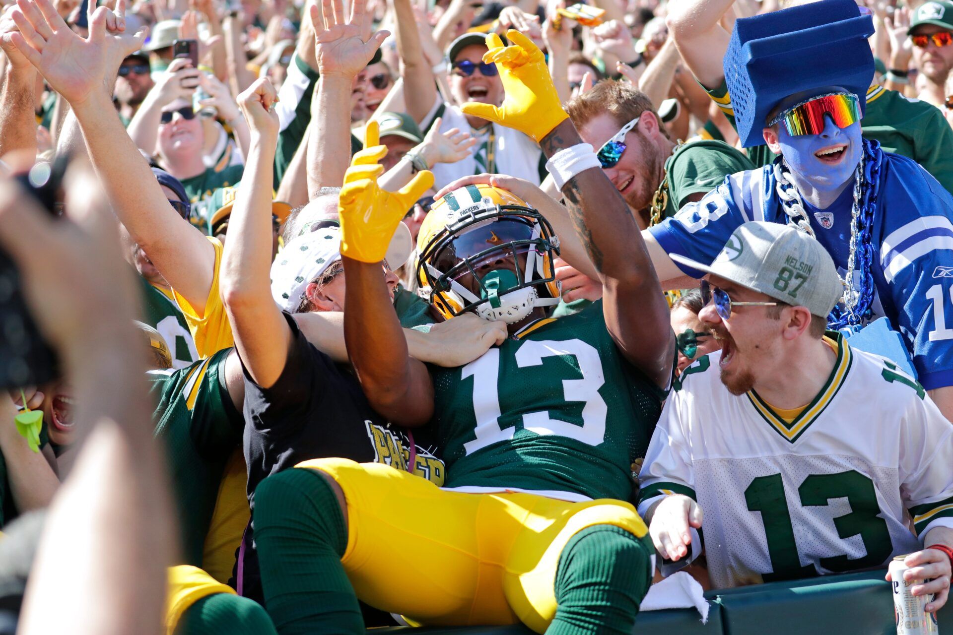 Green Bay Packers wide receiver Dontayvion Wicks (13) celebrates with fans on a Lambeau Leap after scoring a touchdown in the first quarter against the Indianapolis Colts during their football game Sunday, September 15, 2024, at Lambeau Field in Green Bay, Wisconsin.