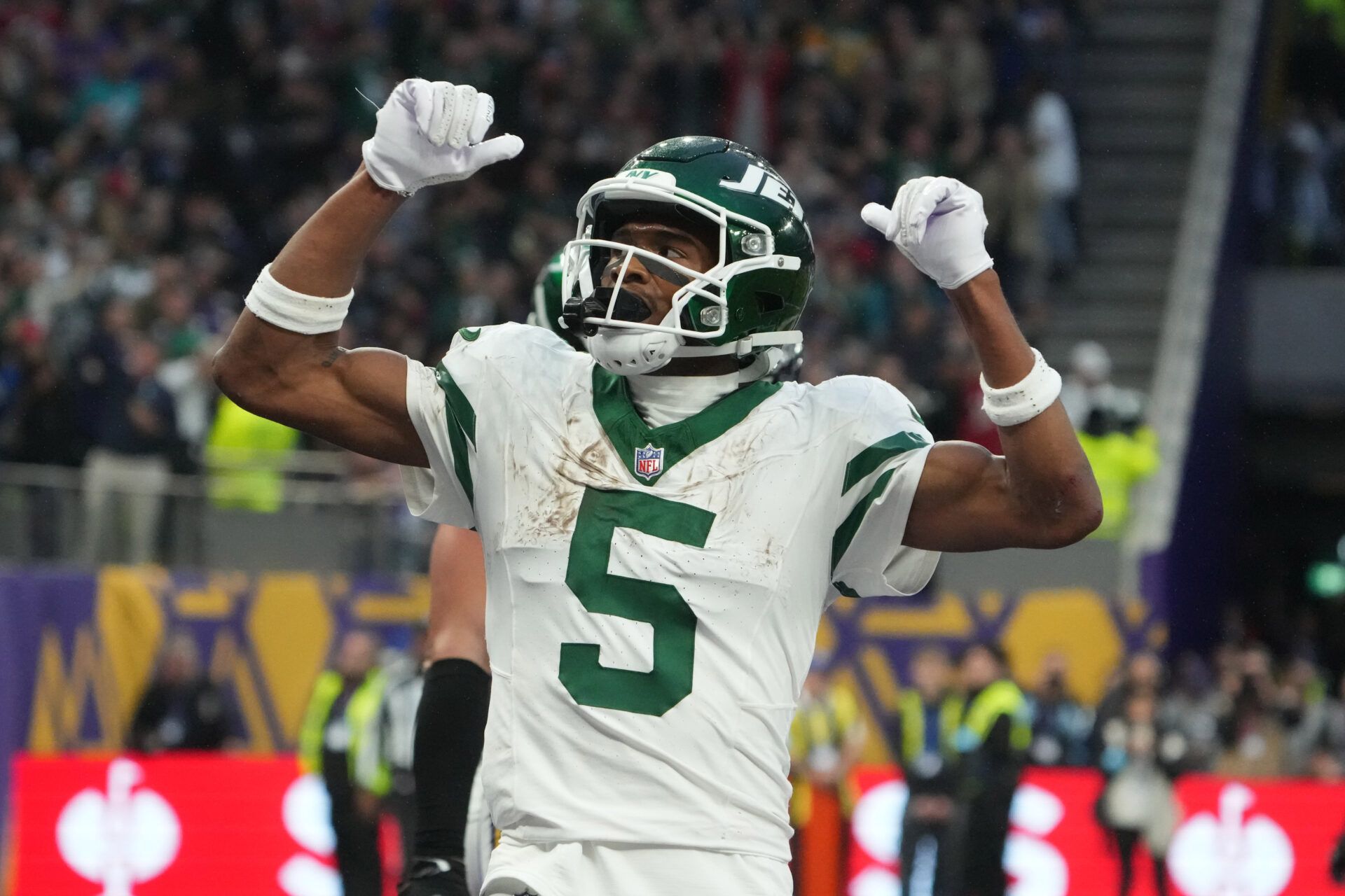 Oct 6, 2024; London, United Kingdom; New York Jets wide receiver Garrett Wilson (5) celebrates after scoring on a 1-yard touchdown reception against the New York Jets in the fourth quarter at Tottenham Hotspur Stadium. Mandatory Credit: Kirby Lee-Imagn Images