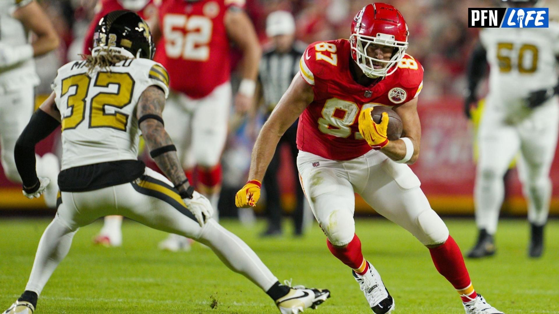 Kansas City Chiefs tight end Travis Kelce (87) runs with the ball against New Orleans Saints safety Tyrann Mathieu (32) during the first half at GEHA Field at Arrowhead Stadium.