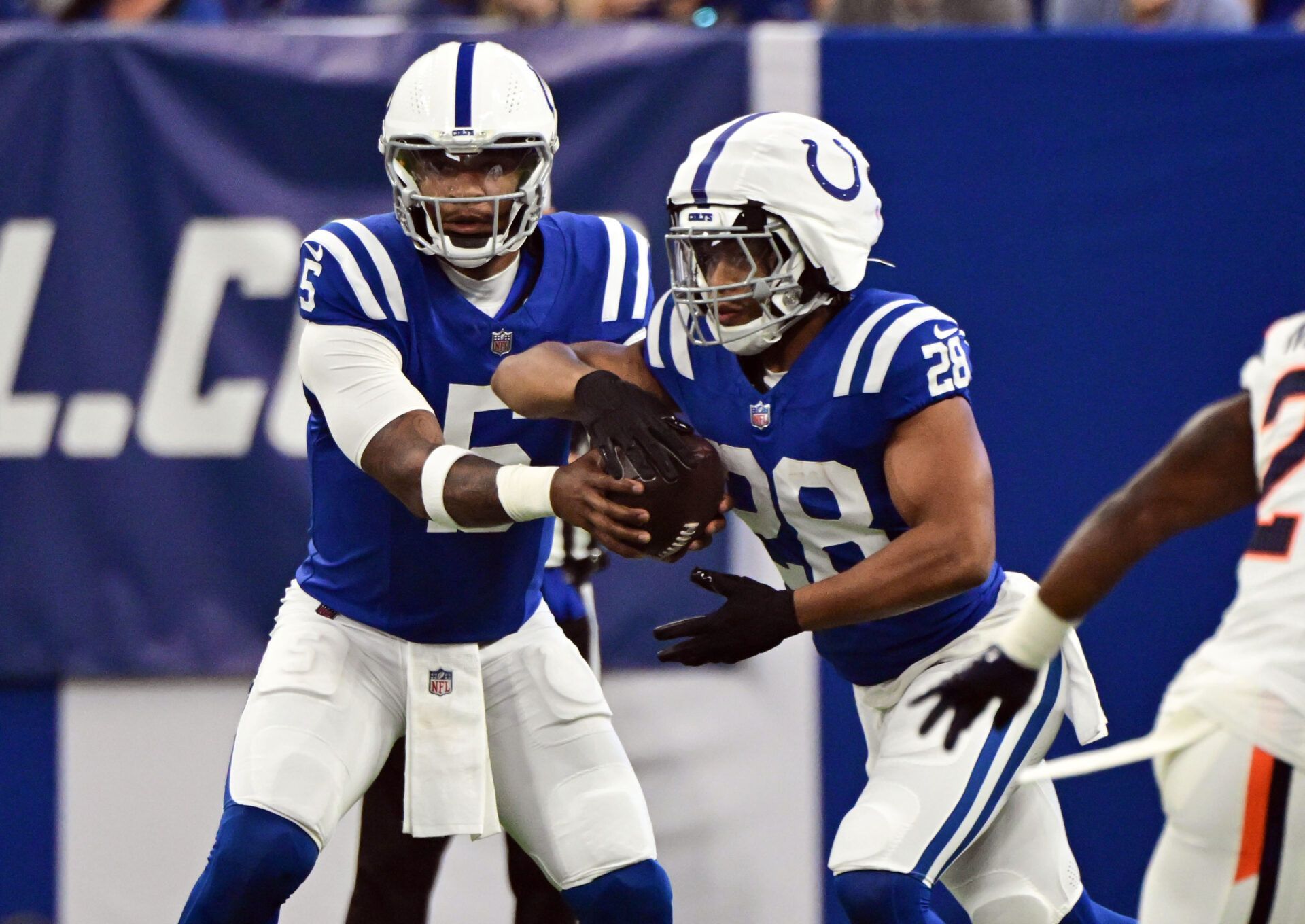 Aug 11, 2024; Indianapolis, Indiana, USA; Indianapolis Colts quarterback Anthony Richardson (5) hands the ball off to Indianapolis Colts running back Jonathan Taylor (28) during the first quarter against the Denver Broncos at Lucas Oil Stadium. Mandatory Credit: Marc Lebryk-USA TODAY Sports