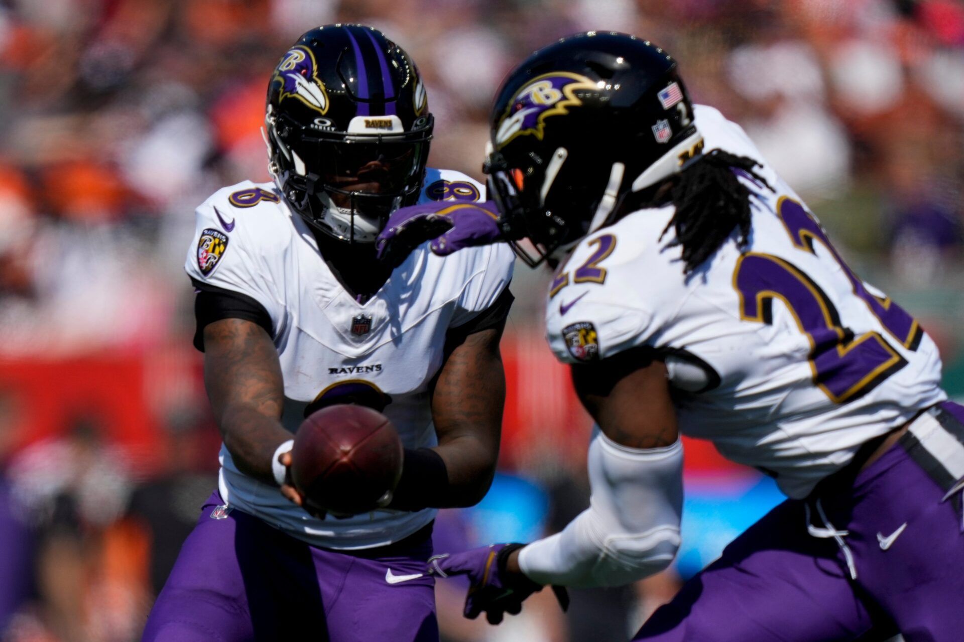 Baltimore Ravens quarterback Lamar Jackson (8) hands off to running back Derrick Henry (22) in the second quarter of the NFL Week 5 game between the Cincinnati Bengals and Baltimore Ravens at Paycor Stadium in downtown Cincinnati on Sunday, Oct. 6, 2024. The Bengals led 17-14 at halftime.