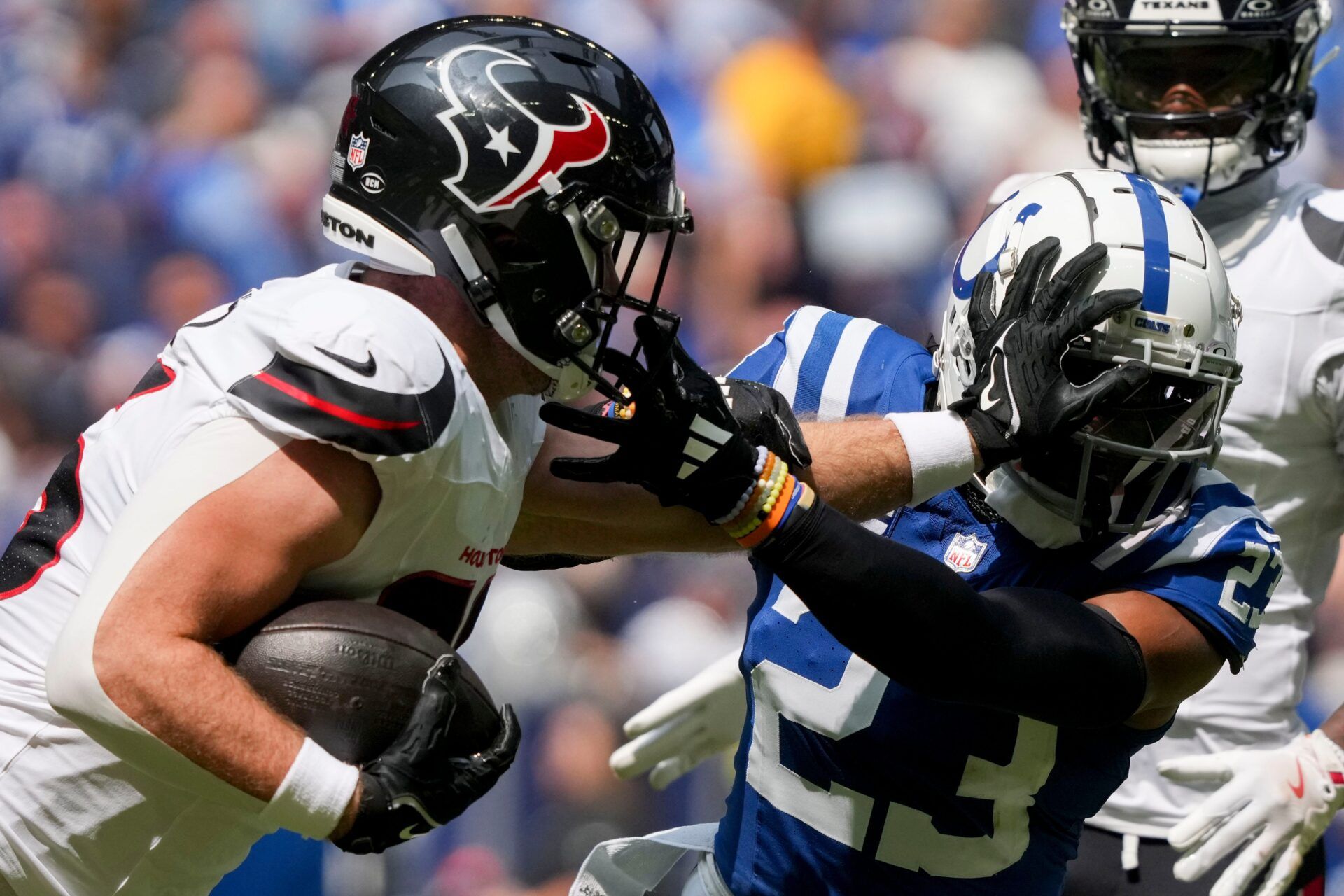 Houston Texans tight end Dalton Schultz (86) pushes off of Indianapolis Colts cornerback Kenny Moore II (23) as he runs with the ball Sunday, Sept. 8, 2024, during a game against the Houston Texans at Lucas Oil Stadium in Indianapolis.