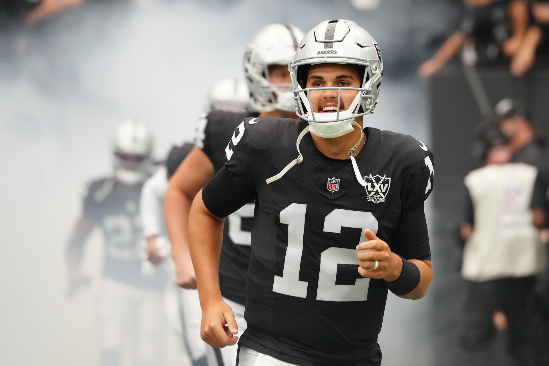 Sep 22, 2024; Paradise, Nevada, USA; Las Vegas Raiders quarterback Aidan O'Connell (12) takes the field before the start of a game against the Carolina Panthers at Allegiant Stadium. Mandatory Credit: Stephen R. Sylvanie-Imagn Images