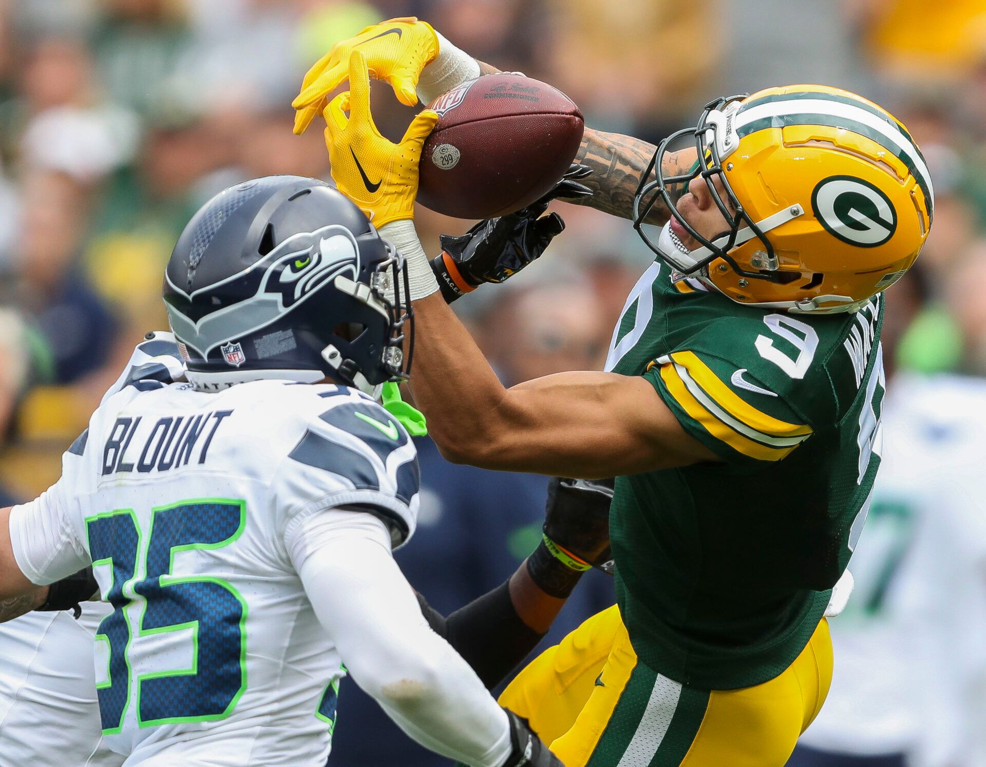 Aug 26, 2023; Green Bay, WI, USA; Green Bay Packers wide receiver Christian Watson (9) has a pass knocked out of his hands by Seattle Seahawks cornerback Michael Jackson during their preseason football game at Lambeau Field. Green Bay defeated Seattle 19-15. Mandatory Credit: Tork Mason-USA TODAY Sports