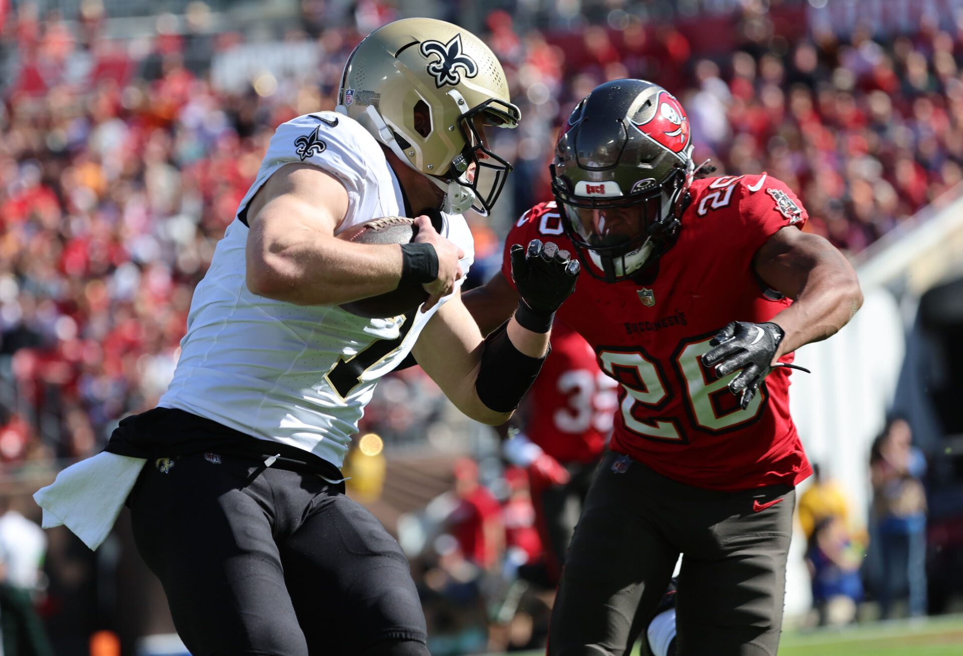 Dec 31, 2023; Tampa, Florida, USA; New Orleans Saints quarterback Taysom Hill (7) runs with the ball as Tampa Bay Buccaneers wide receiver Cephus Johnson (28) defends during the first quarter at Raymond James Stadium. Mandatory Credit: Kim Klement Neitzel-USA TODAY Sports