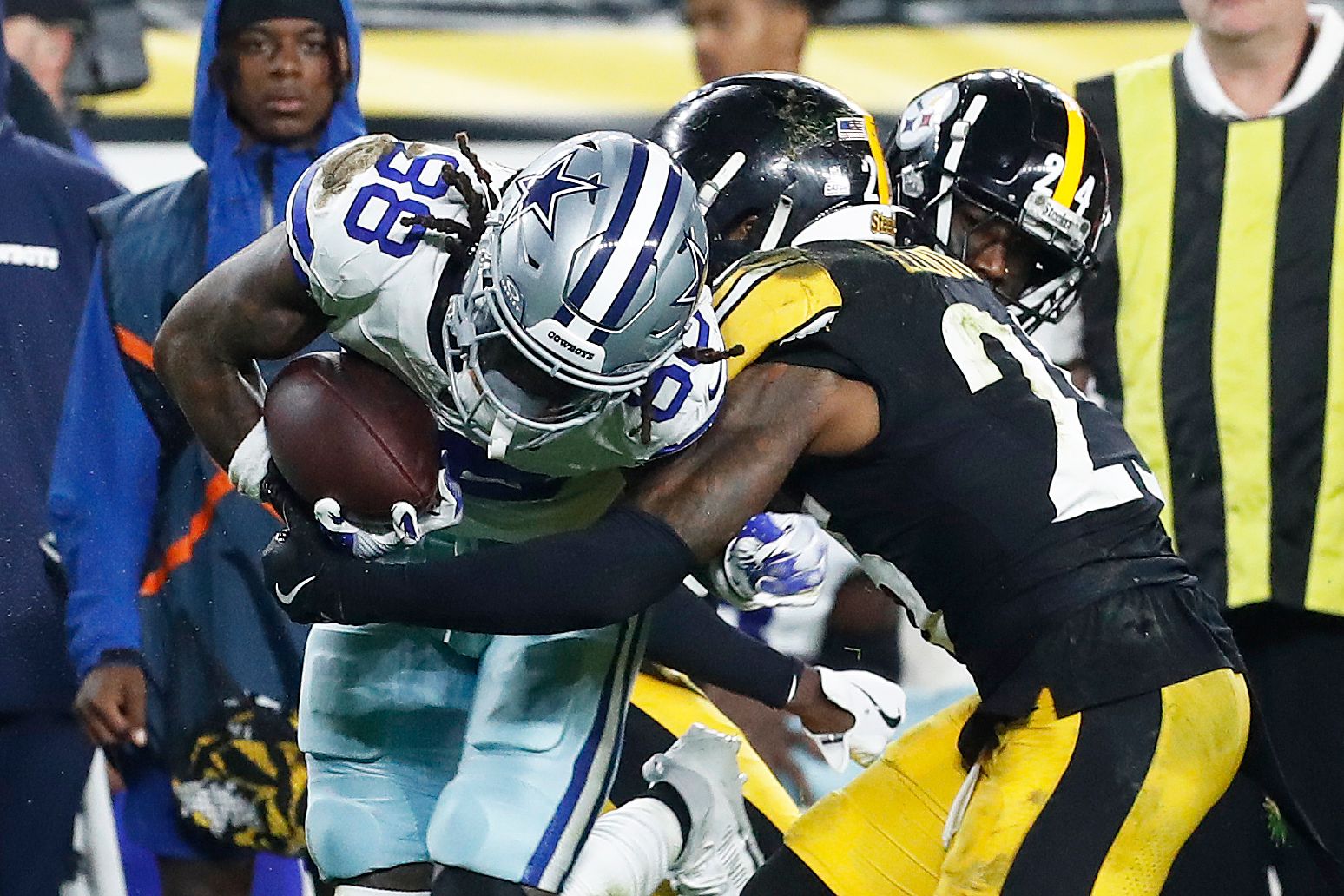 Oct 6, 2024; Pittsburgh, Pennsylvania, USA; Dallas Cowboys wide receiver CeeDee Lamb (88) is tackled after a catch by Pittsburgh Steelers cornerback Joey Porter Jr. (24) and safety Damontae Kazee (23) during the first quarter at Acrisure Stadium. Mandatory Credit: Charles LeClaire-Imagn Images