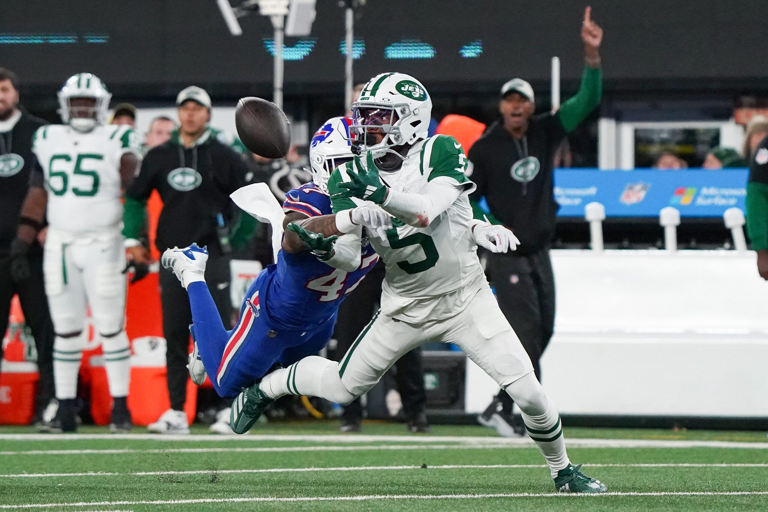 Oct 14, 2024; East Rutherford, New Jersey, USA; New York Jets wide receiver Garrett Wilson (5) attempts a catch as Buffalo Bills cornerback Christian Benford (47) defends during the first half at MetLife Stadium. Mandatory Credit: Lucas Boland-Imagn Images