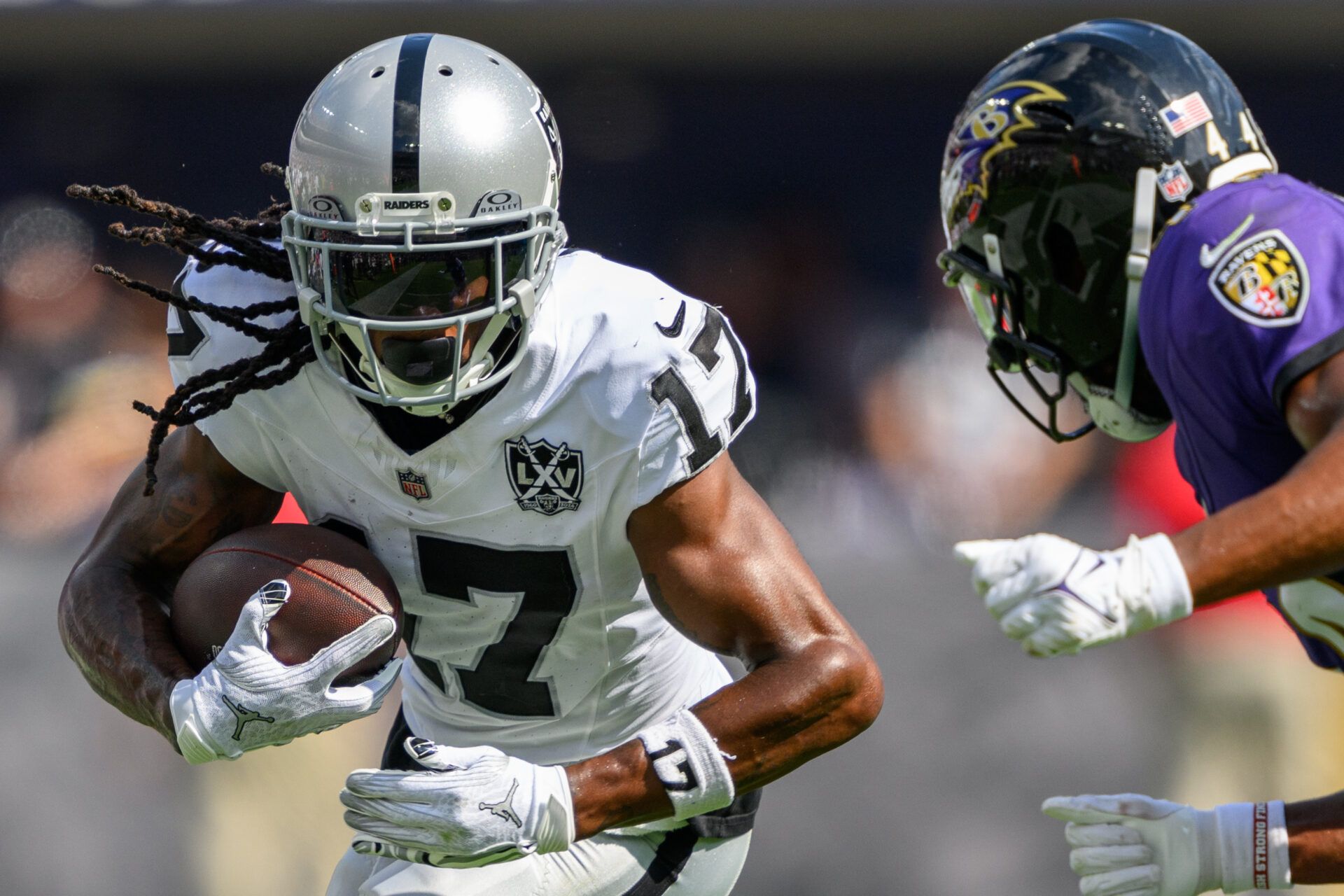 Sep 15, 2024; Baltimore, Maryland, USA; Las Vegas Raiders wide receiver Davante Adams (17) runs with the ball as Baltimore Ravens cornerback Marlon Humphrey (44) defends during the second half at M&T Bank Stadium. Mandatory Credit: Reggie Hildred-Imagn Images