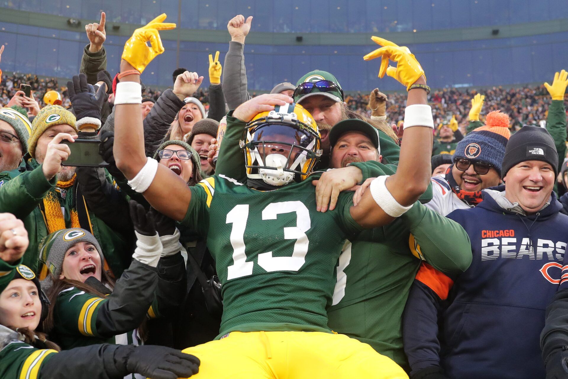 Green Bay Packers wide receiver Dontayvion Wicks (13) celebrates after catching a touchdown pass against Chicago Bears cornerback Terell Smith (32) during their football game Sunday, January 7, 2024, at Lambeau Field in Green Bay, Wis.