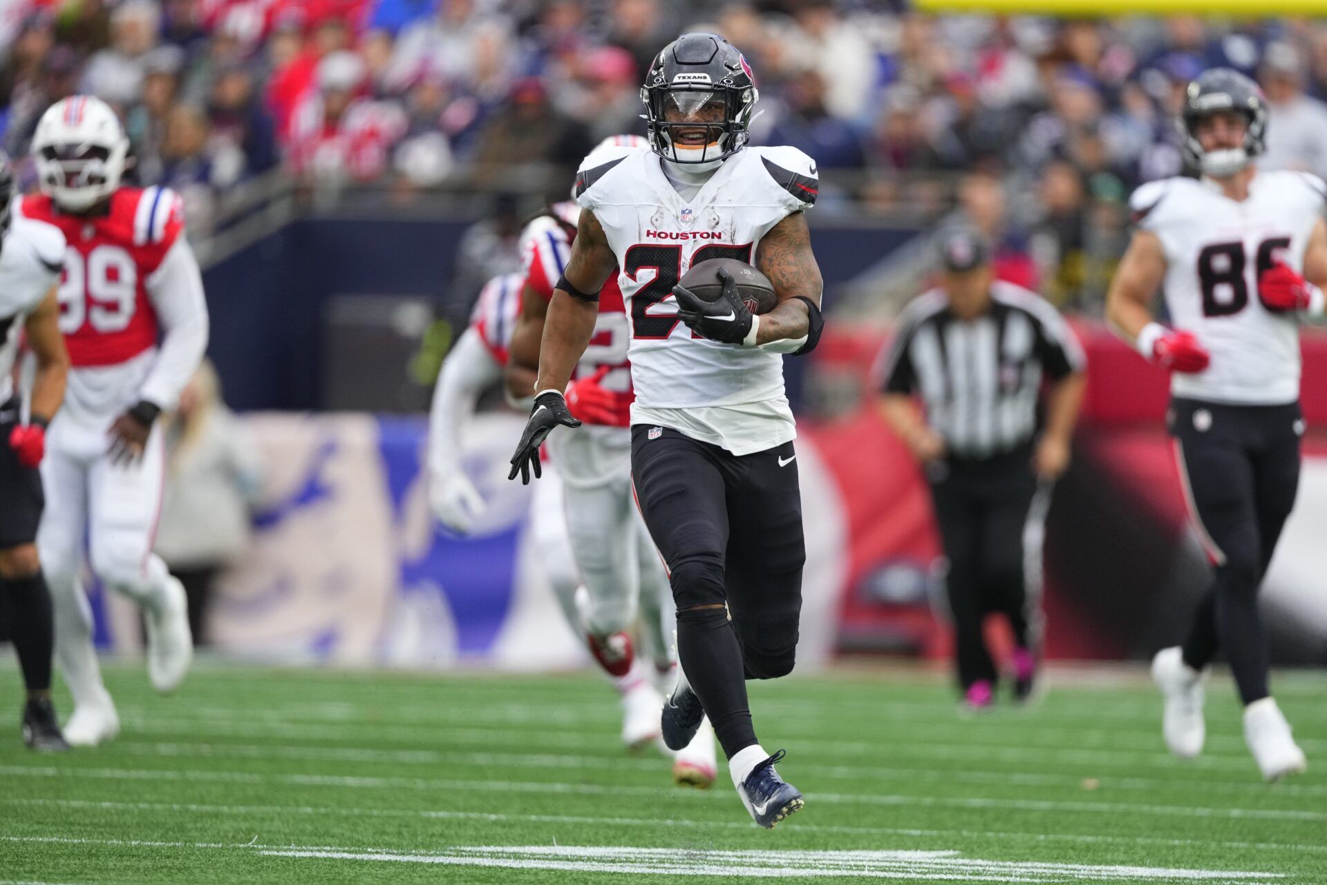 Houston Texans running back Joe Mixon (28) runs with the ball against the New England Patriots during the first half at Gillette Stadium.