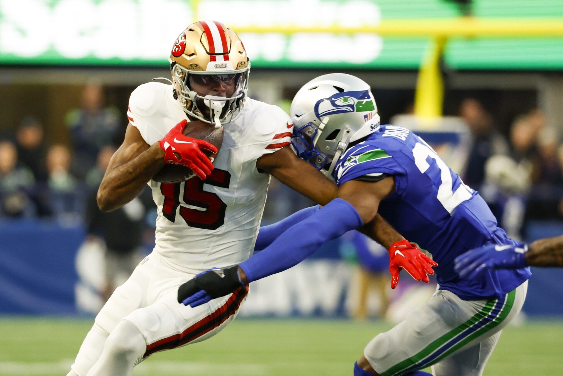 San Francisco 49ers wide receiver Jauan Jennings (15) runs for yards after the catch against Seattle Seahawks cornerback Tre Brown (22) during the second quarter at Lumen Field.