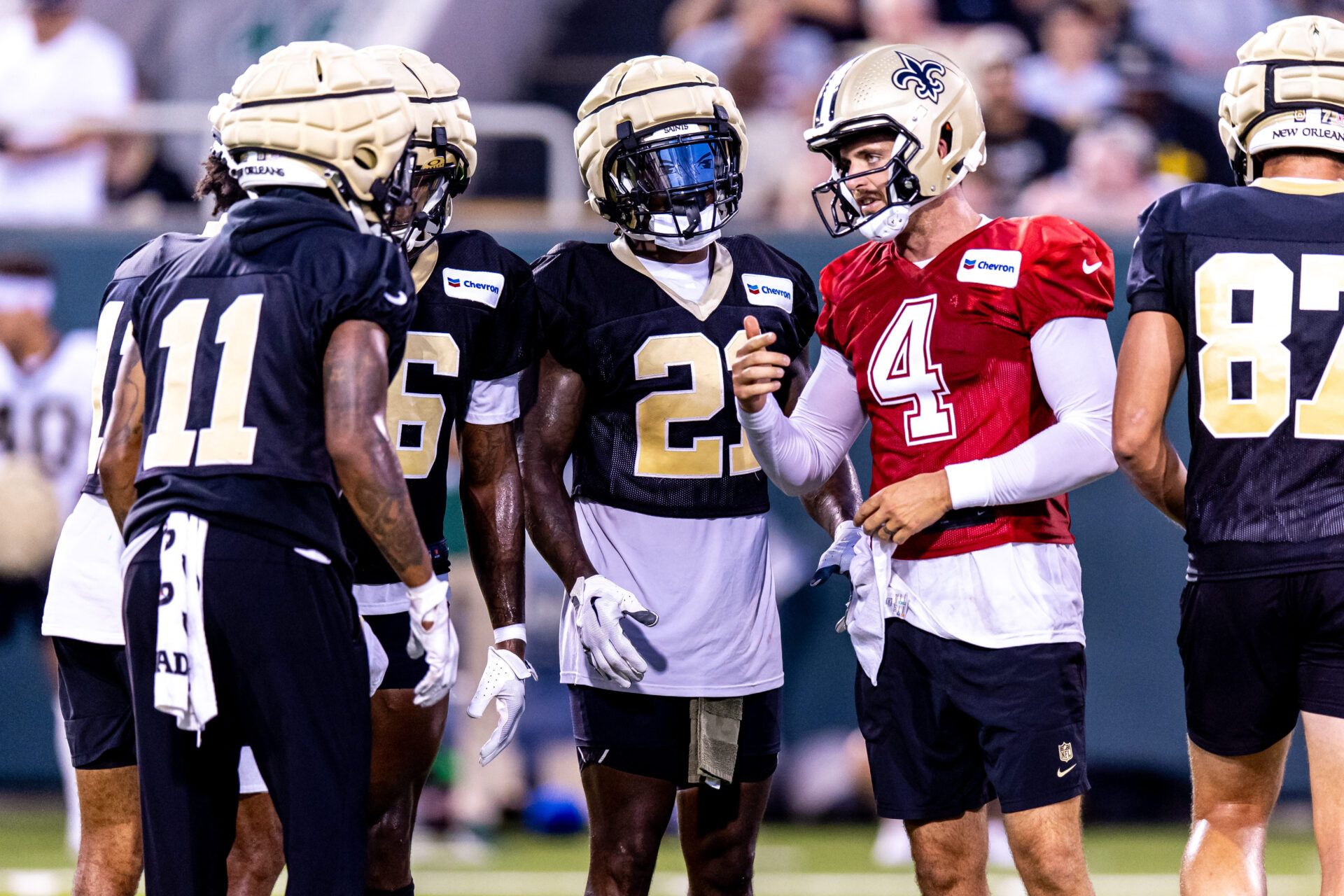 Aug 20, 2024; New Orleans, LA, USA; New Orleans Saints quarterback Derek Carr (4) calls play in the huddle with wide receiver Cedrick Wilson Jr. (11) and running back Jamaal Williams (21) during practice at Yulman Stadium (Tulane). Mandatory Credit: Stephen Lew-USA TODAY Sports