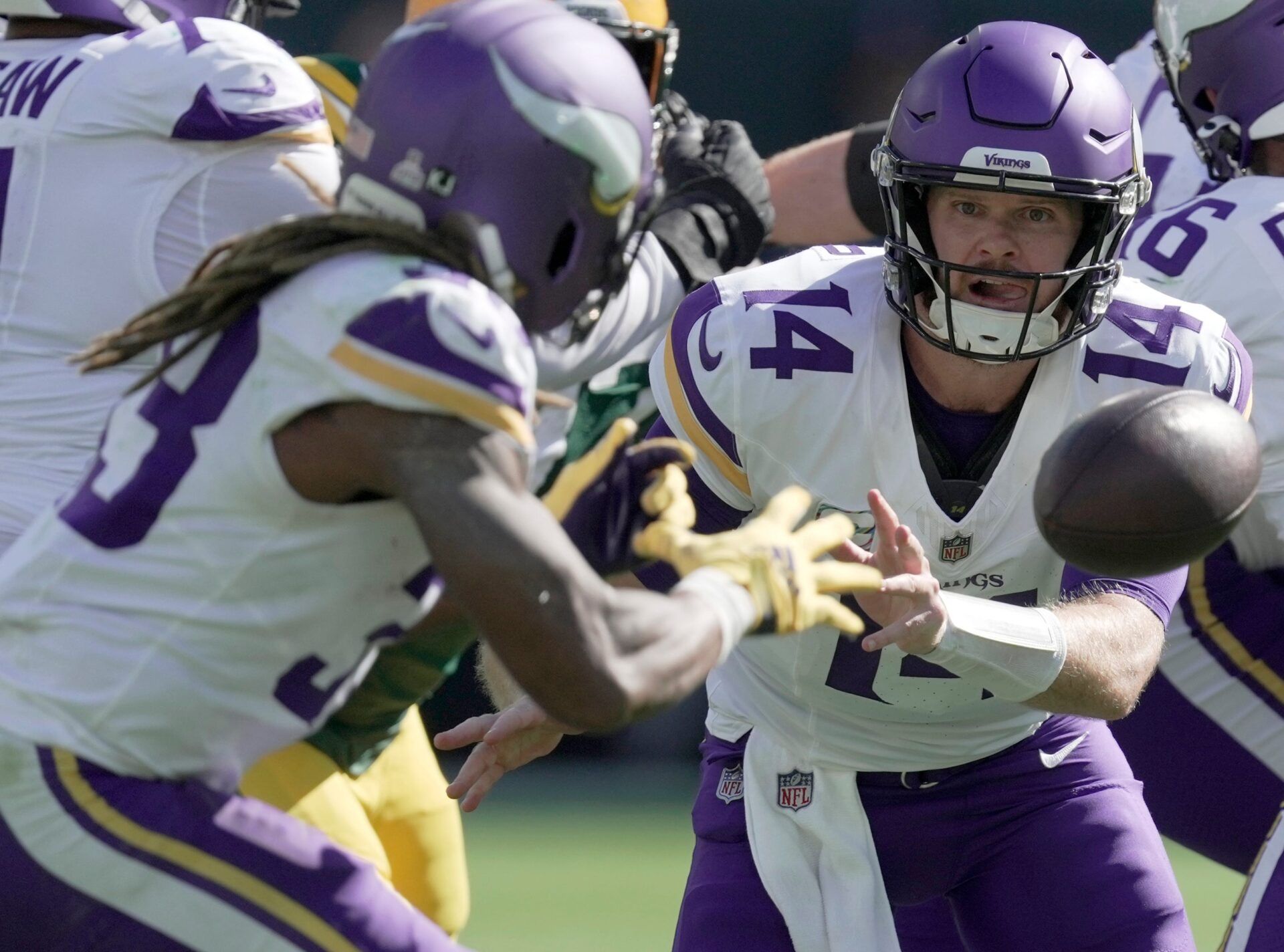 Minnesota Vikings quarterback Sam Darnold (14) pitches the ball to running back Aaron Jones (33) during the third quarter of their game Sunday, September 29, 2024 at Lambeau Field in Green Bay, Wisconsin. The Minnesota Vikings beat the Green Bay Packers 31-29.