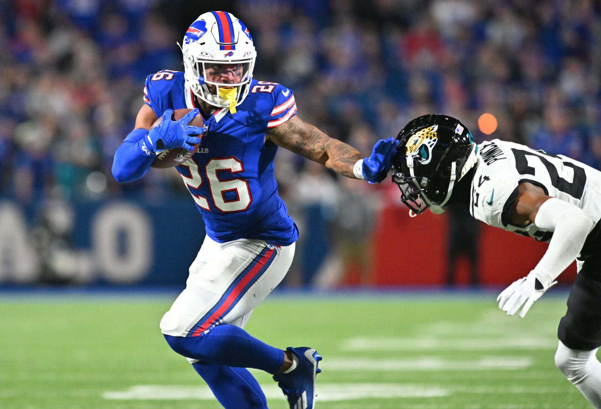 Sep 23, 2024; Orchard Park, New York, USA; Buffalo Bills running back Ty Johnson (26) runs against Jacksonville Jaguars cornerback De'Antre Prince (24) in the fourth quarter at Highmark Stadium. Mandatory Credit: Mark Konezny-Imagn Images