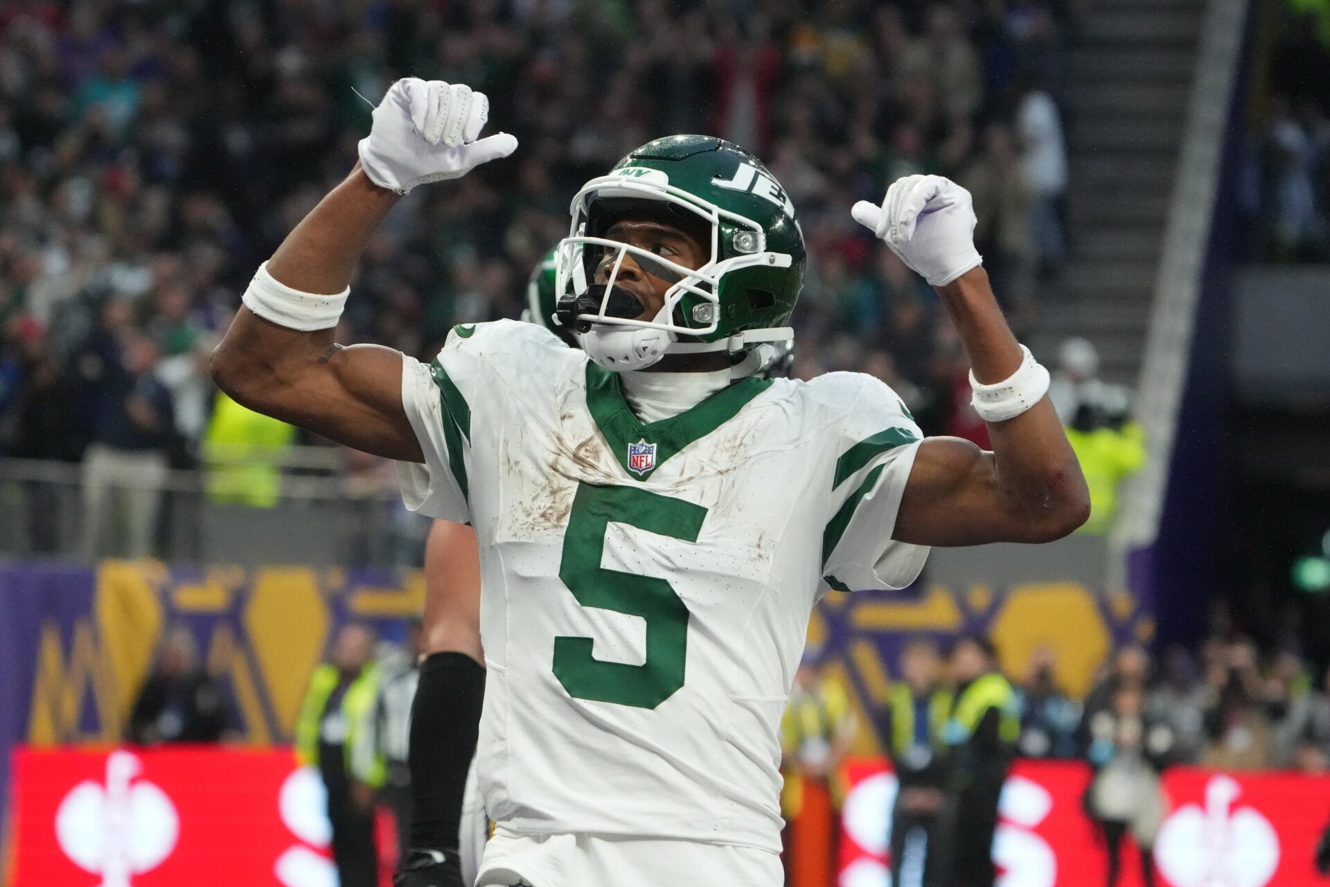 New York Jets wide receiver Garrett Wilson (5) celebrates after scoring on a 1-yard touchdown reception against the New York Jets in the fourth quarter at Tottenham Hotspur Stadium.