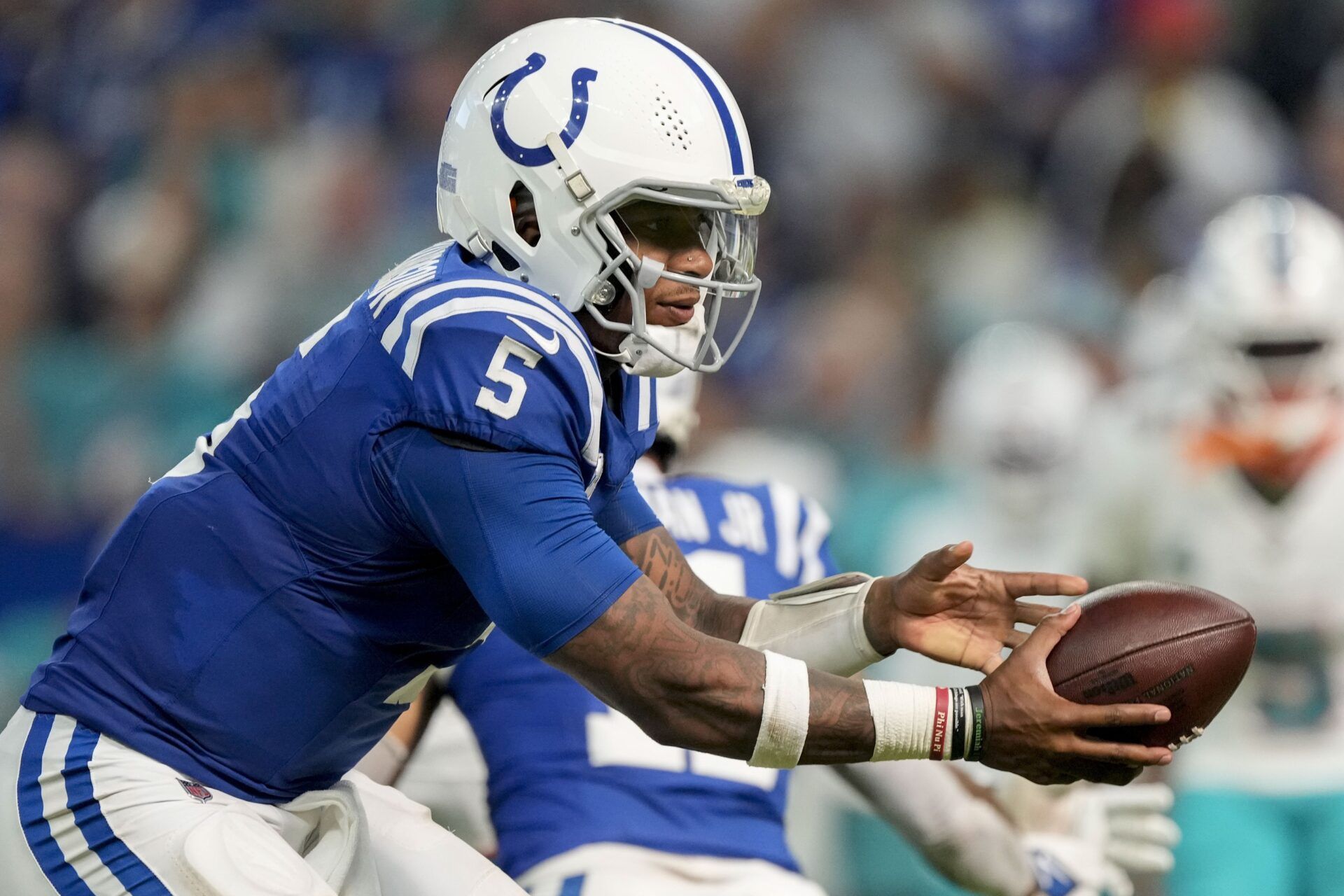 Indianapolis Colts quarterback Anthony Richardson (5) catches the snap during a game against the Miami Dolphins at Lucas Oil Stadium.