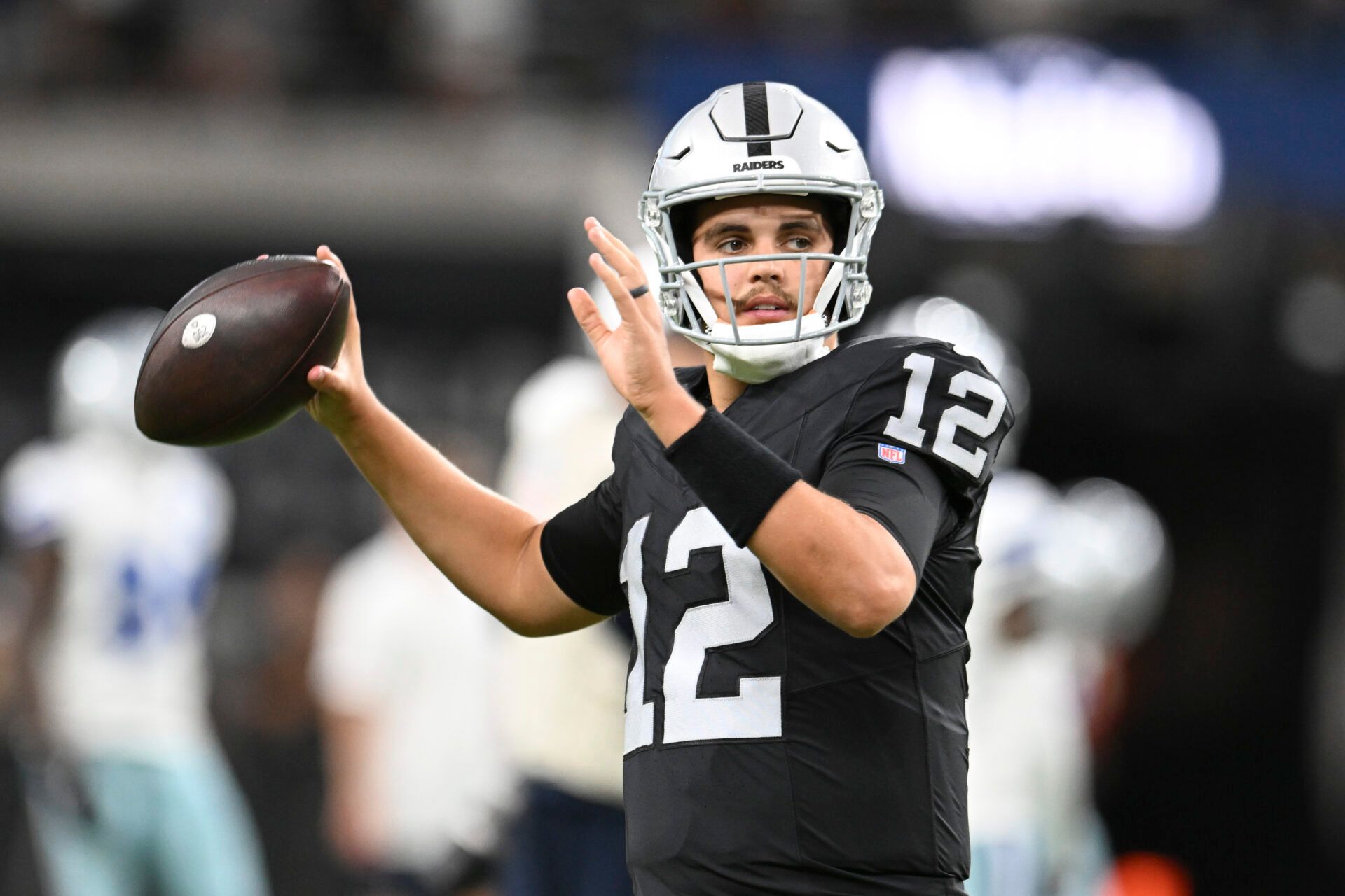 Las Vegas Raiders quarterback Aidan O'Connell (12) warms up against the Dallas Cowboys at Allegiant Stadium.