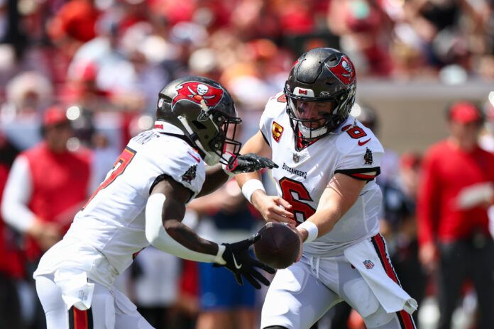 Sep 22, 2024; Tampa, Florida, USA; Tampa Bay Buccaneers quarterback Baker Mayfield (6) hands off to running back Bucky Irving (7) against the Denver Broncos in the second quarter at Raymond James Stadium. Mandatory Credit: Nathan Ray Seebeck-Imagn Images