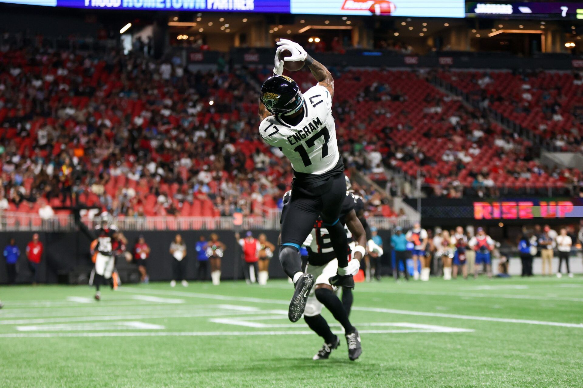 Aug 23, 2024; Atlanta, Georgia, USA; Jacksonville Jaguars tight end Evan Engram (17) catches a touchdown pass past Atlanta Falcons cornerback Anthony Johnson (43) in the second quarter at Mercedes-Benz Stadium. Mandatory Credit: Brett Davis-USA TODAY Sports