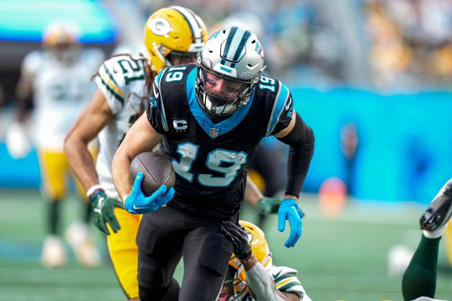 Dec 24, 2023; Charlotte, North Carolina, USA; Carolina Panthers wide receiver Adam Thielen (19) avoids a tackled by Green Bay Packers safety Anthony Johnson Jr. (36) during the second half at Bank of America Stadium. Mandatory Credit: Jim Dedmon-USA TODAY Sports