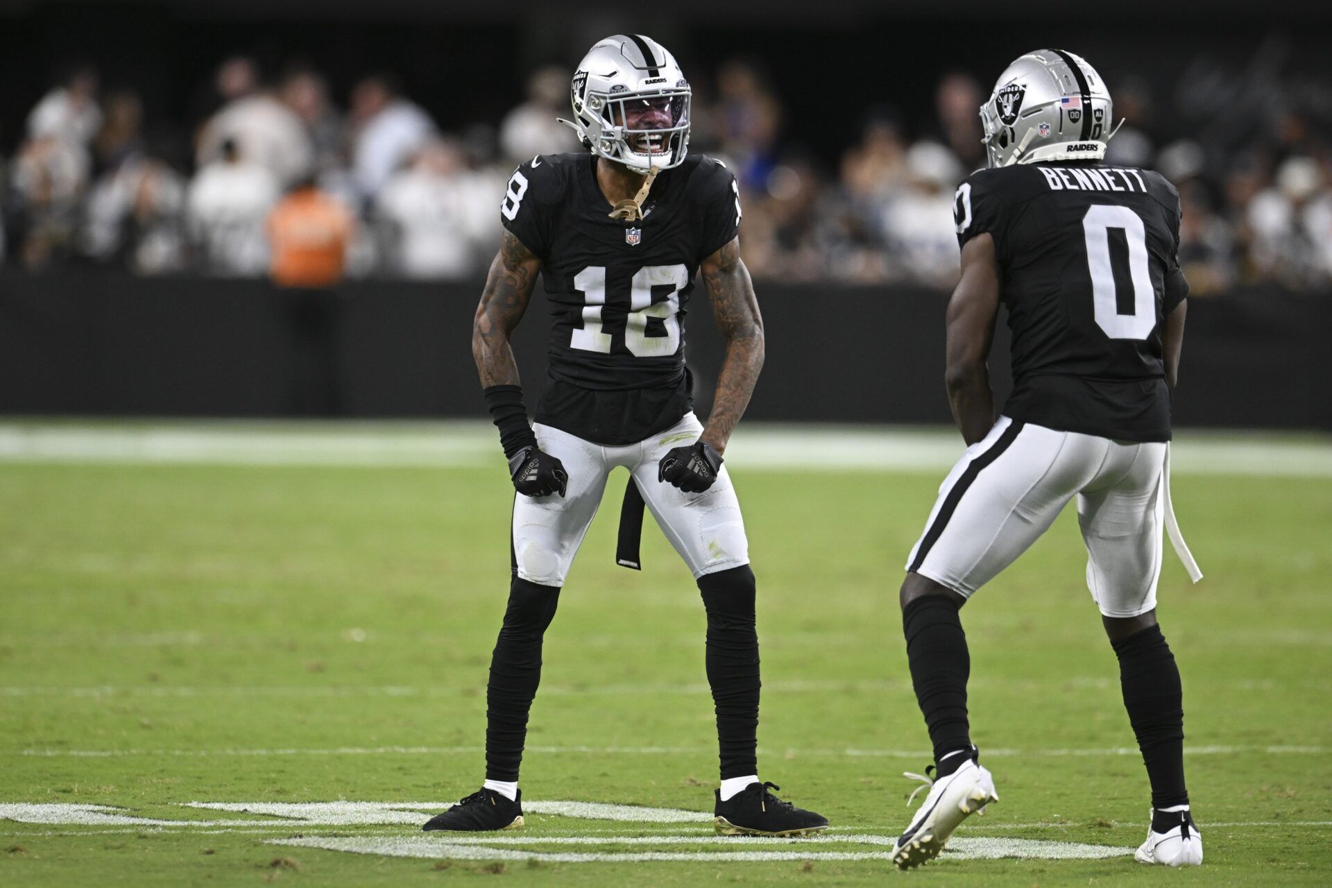 Las Vegas Raiders cornerback Jack Jones (18) and cornerback Jakorian Bennett (0) celebrate a play against the Dallas Cowboys in the first quarter at Allegiant Stadium.