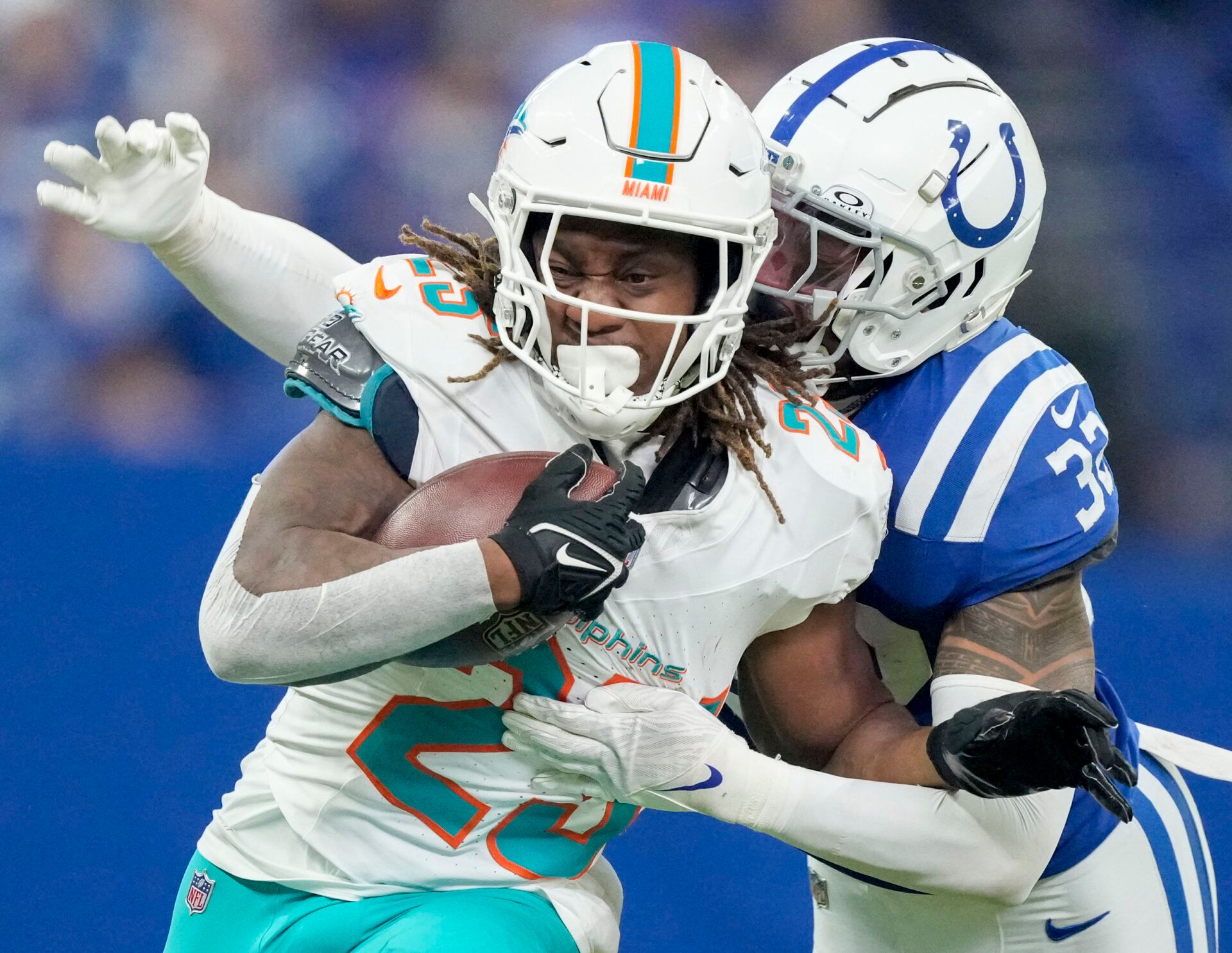 Oct 20, 2024; Indianapolis, Indiana, USA; Indianapolis Colts safety Julian Blackmon (32) works to bring down Miami Dolphins running back Jaylen Wright (25) during a game against the Miami Dolphins at Lucas Oil Stadium. Mandatory Credit: Grace Hollars/IndyStar USA TODAY Network via Imagn Images