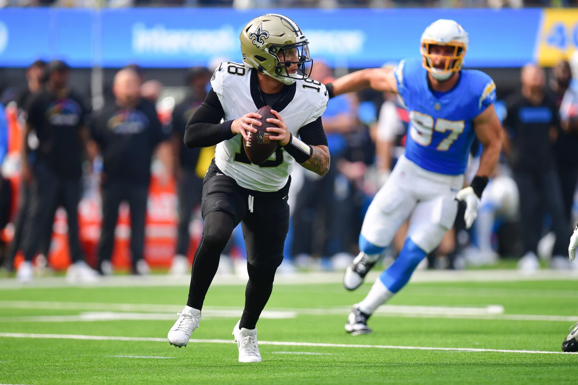 New Orleans Saints quarterback Spencer Rattler (18) runs out to pass against the Los Angeles Chargers during the first half at SoFi Stadium.